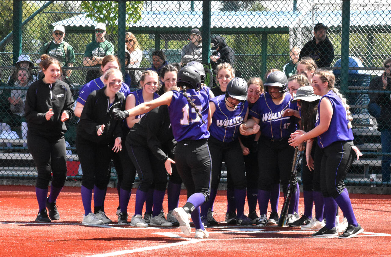 Photo by Kevin Hanson/Enumclaw Courier-Herald 
Sequim teammates celebrate Taylee Rome’s home run over the left field fence in the Wolves’ 21-1 rout of Sammamish on May 20, a win that secured Sequim a berth in the state 2A tournament.