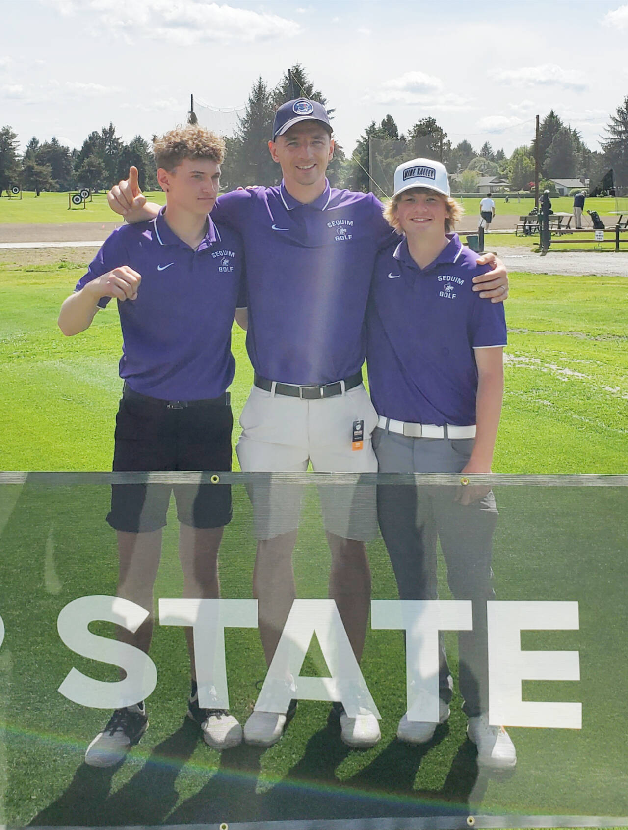 From left, Sequim’s Dominic Riccobene, coach Sean O’Mera and Ben Sweet celebrate Sequim’s fifth-place finish at the state 2A golf championship at the Capitol City Golf Club in Olympia. Submitted photo