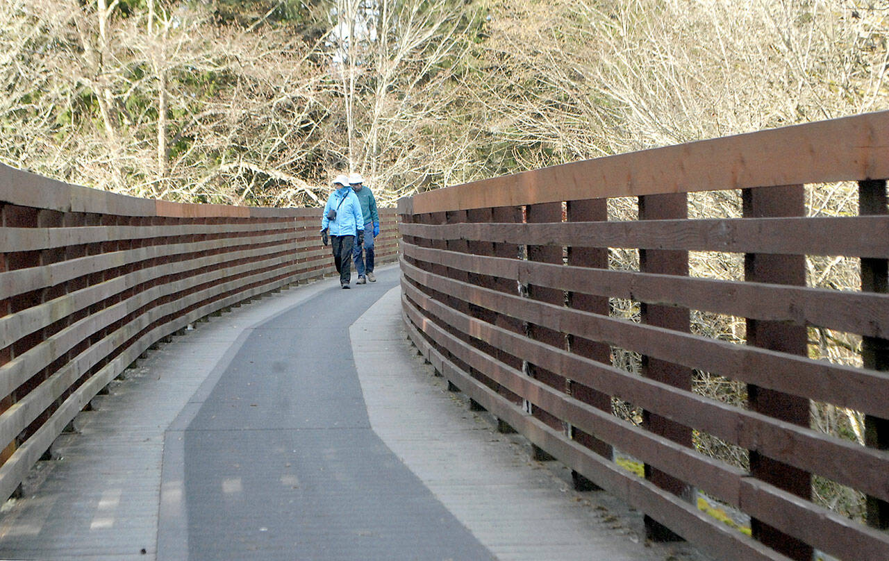 Joan and Bill Henry of Sequim stroll along the Johnson Creek Trestle, part of the Olympic Discovery Trail spanning Johnson Creek east of Sequim, in February 2021. The 410-foot-long trestle which refurbished in 2003 from a former railroad span and opened to pedestrian traffic is undergoing an inspection June 6-10 and will be closed. File photo by Keith Thorpe/Olympic Peninsula News Group