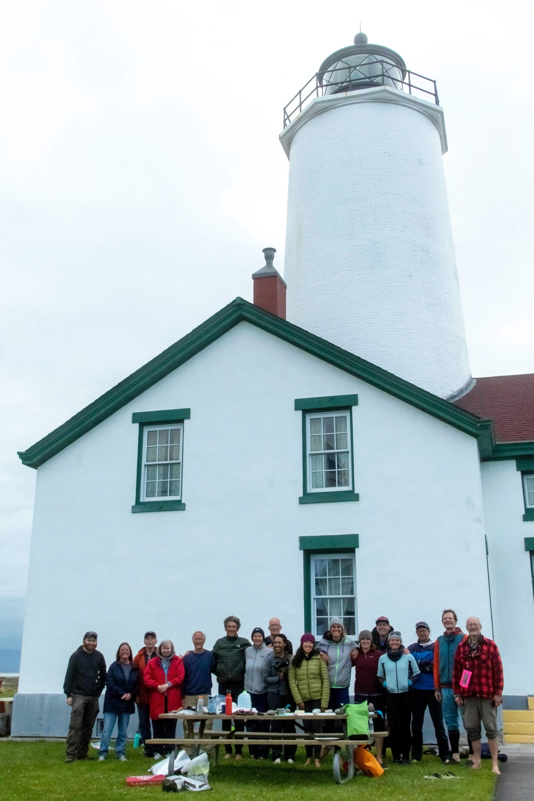 Photo by John Lato III 
Race 2 Alaska participants who were stranded at the lighthouse join lighthouse keepers and race event staffers at the Dungeness Lighthouse on June 14.