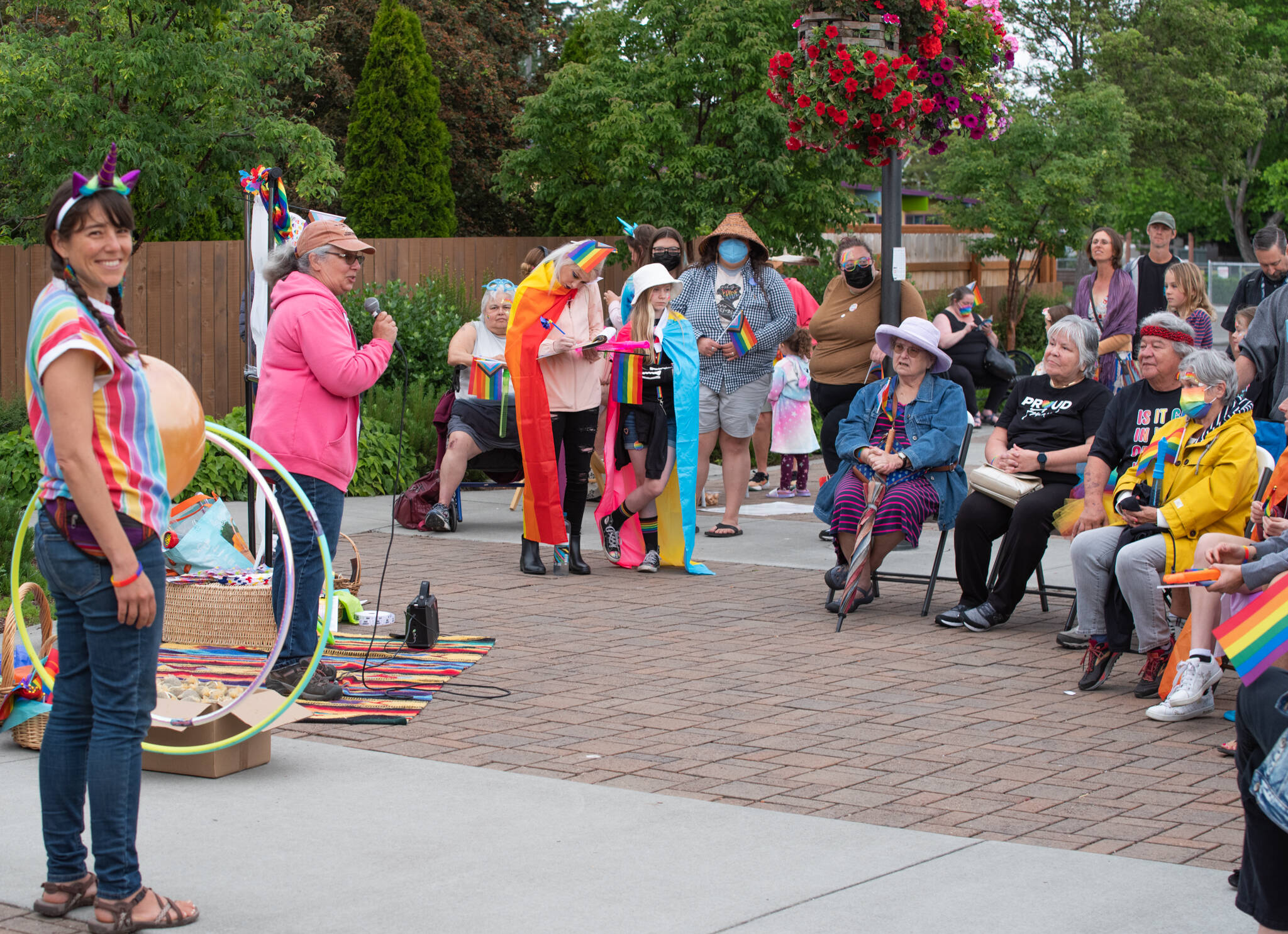 Sequim Gazette photso by Emily Matthiessen 
Emma Barrell smiles as Kathy Ohm speaks at a Pride Month Celebration at the Sequim Civic Center held Tuesday, June 28, sponsored by the Jamestown S’Klallam Tribe. Organizer Michael Lowe said that 125-200 people flowed in and out of the joyful event.