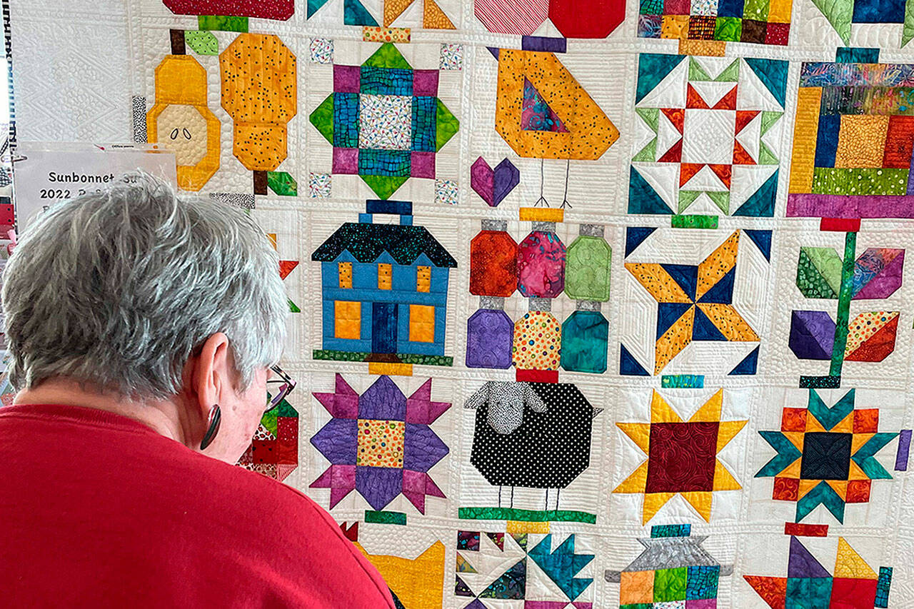 Sequim Gazette file photo by Matthew Nash
“Down on the Farm” was pieced together by Bonnie Filgo, pictured, quilted by Dory Miller and finished by Bonnie Cauffman. It will be on display at the Sunbonnet Sue Quilt Show on July 16 at Pioneer Memorial Park.