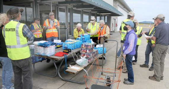 Clallam County Disaster Airlift Response Team members assemble food and water for a training session on Saturday at William R. Fairchild International Airport in Port Angeles that sent food supplies to five smaller airports across the county. (Keith Thorpe/Peninsula Daily News)