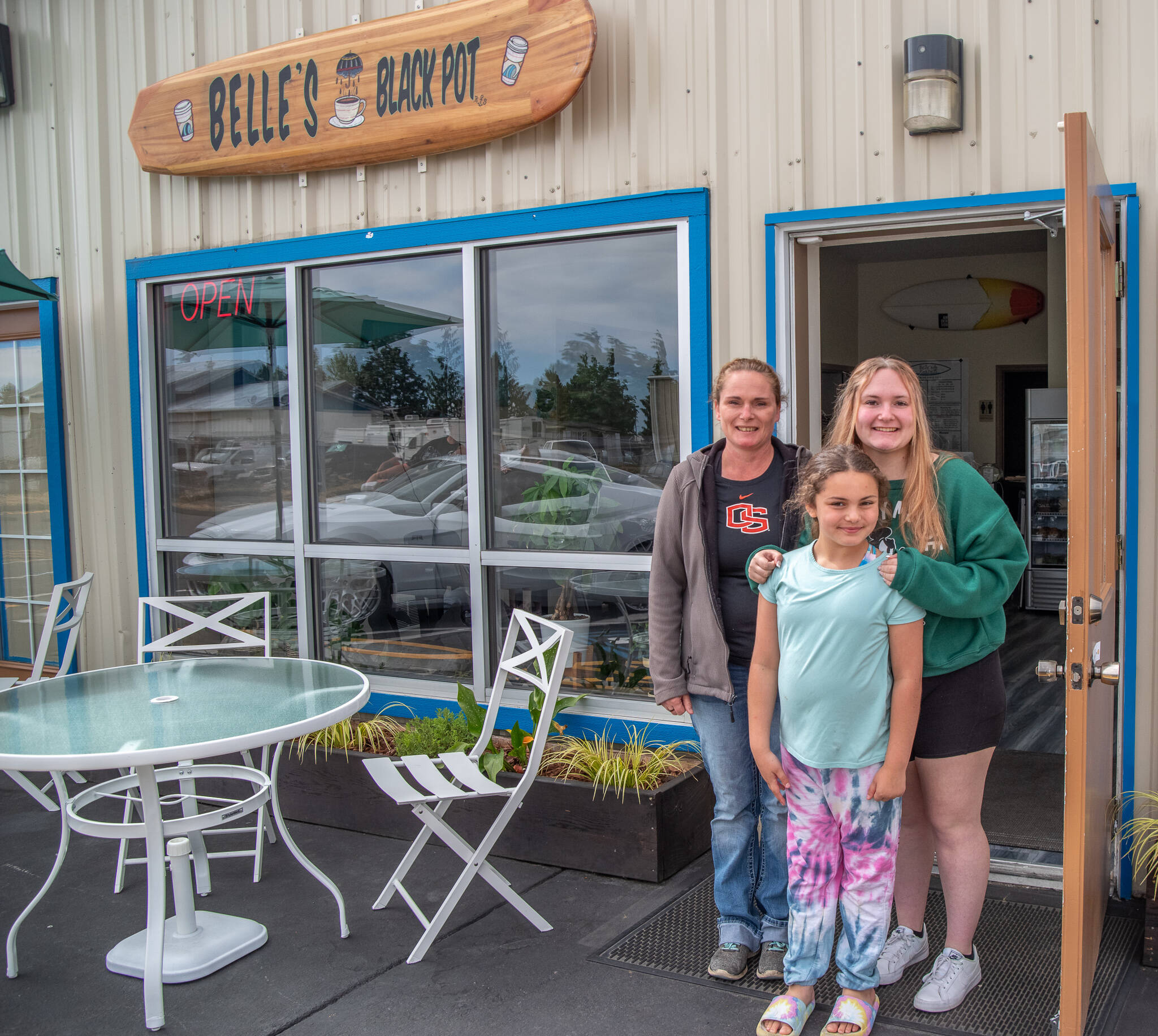 Sequim Gazette photo by Emily Matthiessen
Heather, Olivia and Samantha Owen stand outside Belle’s Black Pot at 131 River Road in Sequim. The beach-themed coffeehouse and deli specializes in old favorites and new flavor combinations, both in drinks and food.
