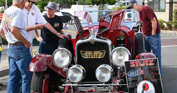 Sequim Gazette file photo by Michael Dashiell
Wayne Caldwell of Sequim, second from left, discusses his Stutz sports car, a 1927 AA Black-Hawk boat-tail two-passenger speedster, with attendees of the Sequim Prairie Nights event in downtown Sequim in 2021.