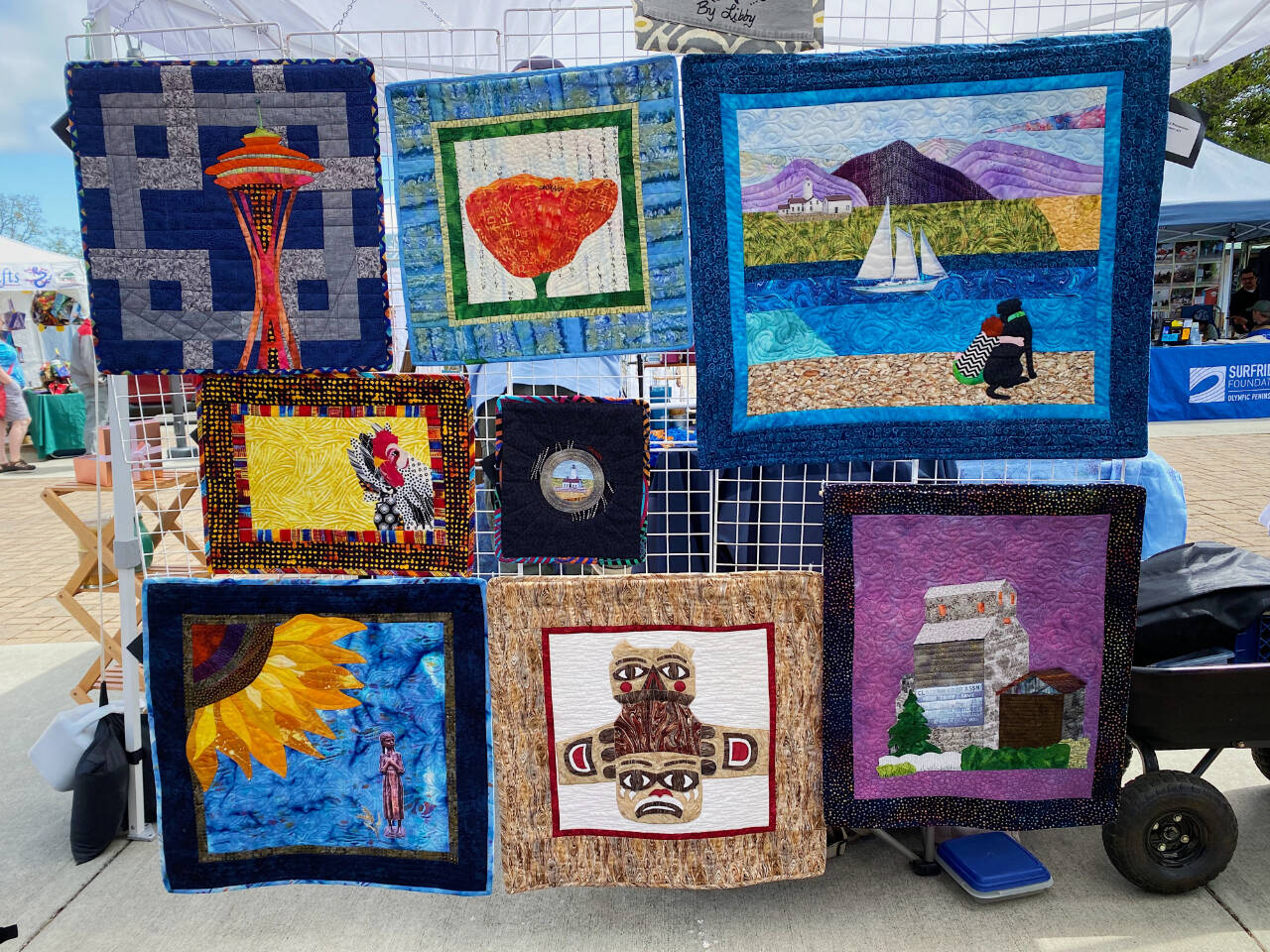 Photo by Emma Jane Garcia/Sequim Farmers & Artisans Market / Libby Ballard’s hand-crafted, upcycled, and environmentally friendly clothing, aprons, bags, fabric household essentials and art quilts are on display at the Sequim Farmers & Artisans Market.