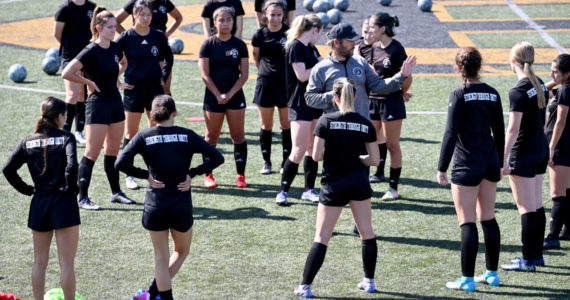 Photo courtesy of Peninsula College 
Coach Kanyon Anderson works with members fo the Peninsula College women's soccer team at a practice earlier this month. The women are defending NWAC champions.