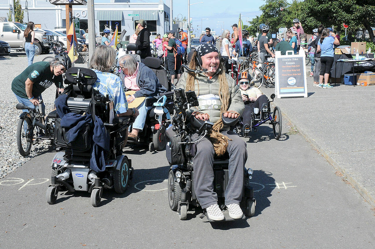Photo by Keith Thorpe/Olympic Peninsula News Group / Ian Mackay of Agnew, center, prepares to lead a group of wheelchair, bicyclists, runners and others on a portion of Sea-to-Sound, a three-day, 74-mile multi-modal group ride along a section of the Waterfront Trail in Port Angeles on Aug. 27. The excursion, which followed numerous portions of the Olympic Discovery from west of Lake Crescent to the Larry Scott Trail in Jefferson County, ended Aug. 28. It was organized through Ian’s Ride, a nonprofit organization the advocates outdoor accessibility for all.