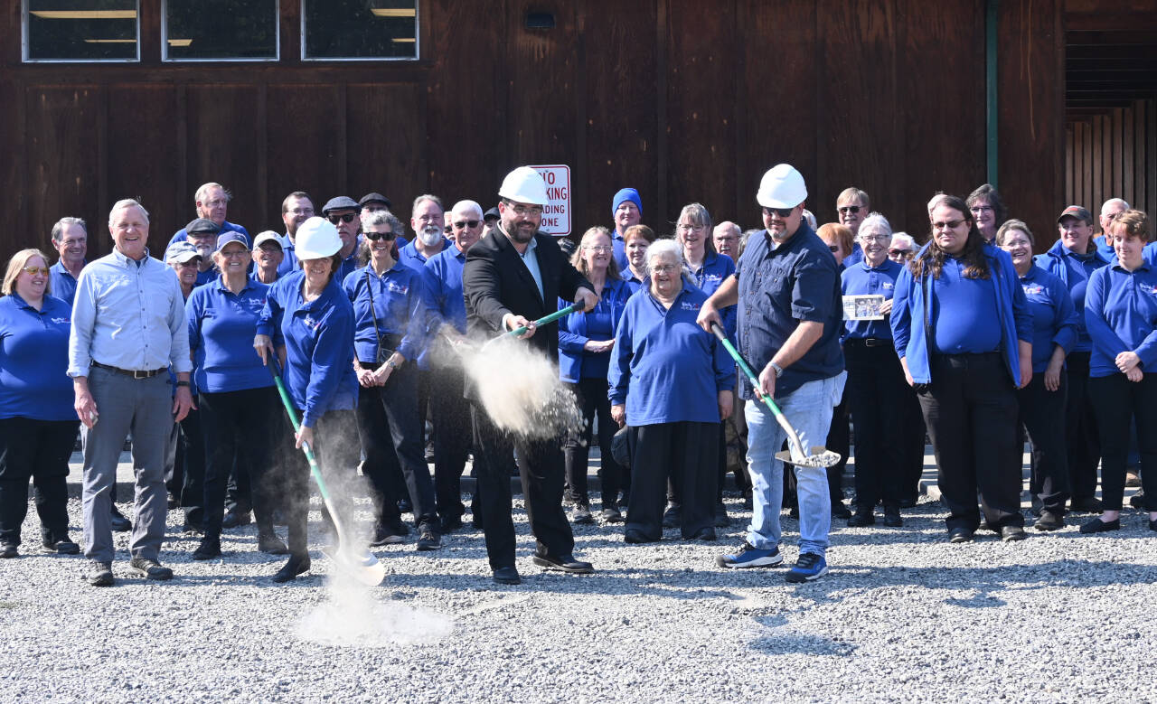 Sequim Gazette photo by Michael Dashiell
Sequim City Band members “break ground” on the Rehearsal Hall expansion project on Sept. 10. Pictured with ceremonial shovels are, from left, band president Debbi Soderstrom, band director Tyler Benedict and Neeley Construction superintendent Eli Collier.