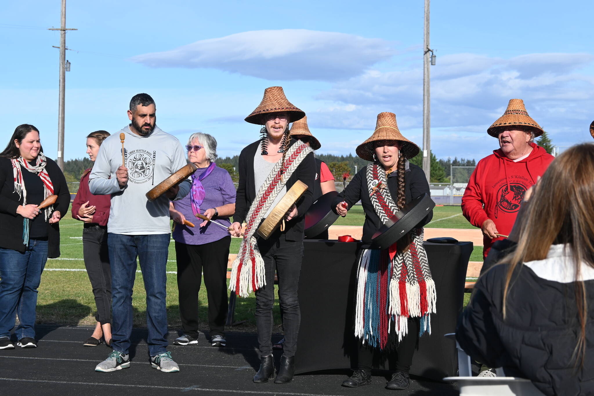 Sequim Gazette photo by Michael Dashiell / The S’Klallam Singers offer “Happy song” at the Sequim School District’s stadium and field naming ceremony on Sept. 16. The stadium was official named stáʔčəŋ, a S’Klallam word pronounced “stah-chung” and meaning “wolf,” and the field to Myron Teterud’s Field, after the longtime, late SHS sports fanatic.