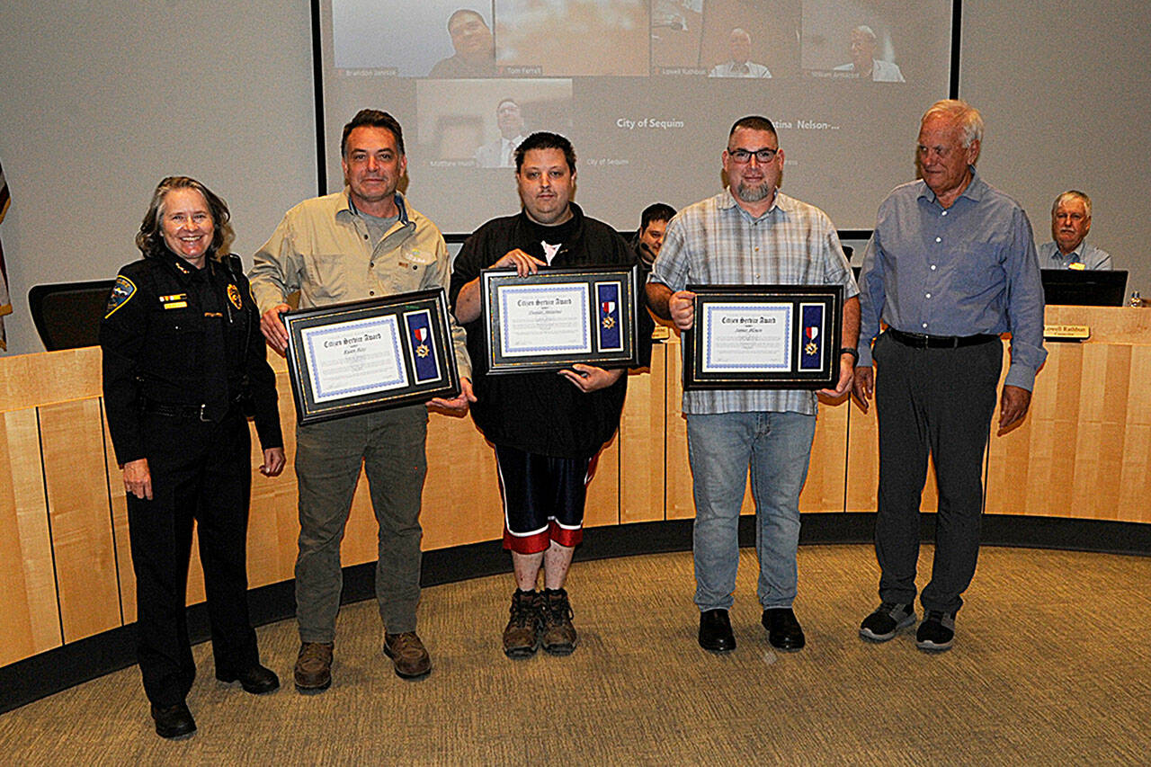 Sequim Gazette photo by Matthew Nash
For their efforts to help save a Sequim police officer being attacked in May, Ryan Ross, Daniel Anselmo, and James “Mike” Blouin were honored with Citizen Commendation Awards on Sept. 12 by Sequim Police Chief Sheri Crain and Sequim mayor Tom Ferrell.