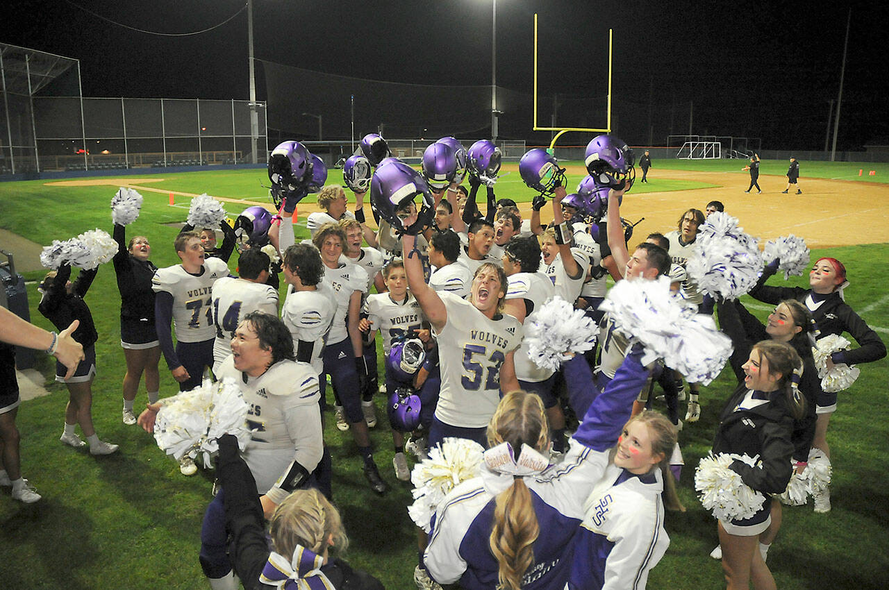 Photo by Keith Thorpe/Olympic Peninsula News Group / Members of the Sequim Wolves football team and cheer squad celebrate a 36-32 come-from-behind victory over the Port Angeles Roughriders at Port Angeles Civic Field on Sept. 23.