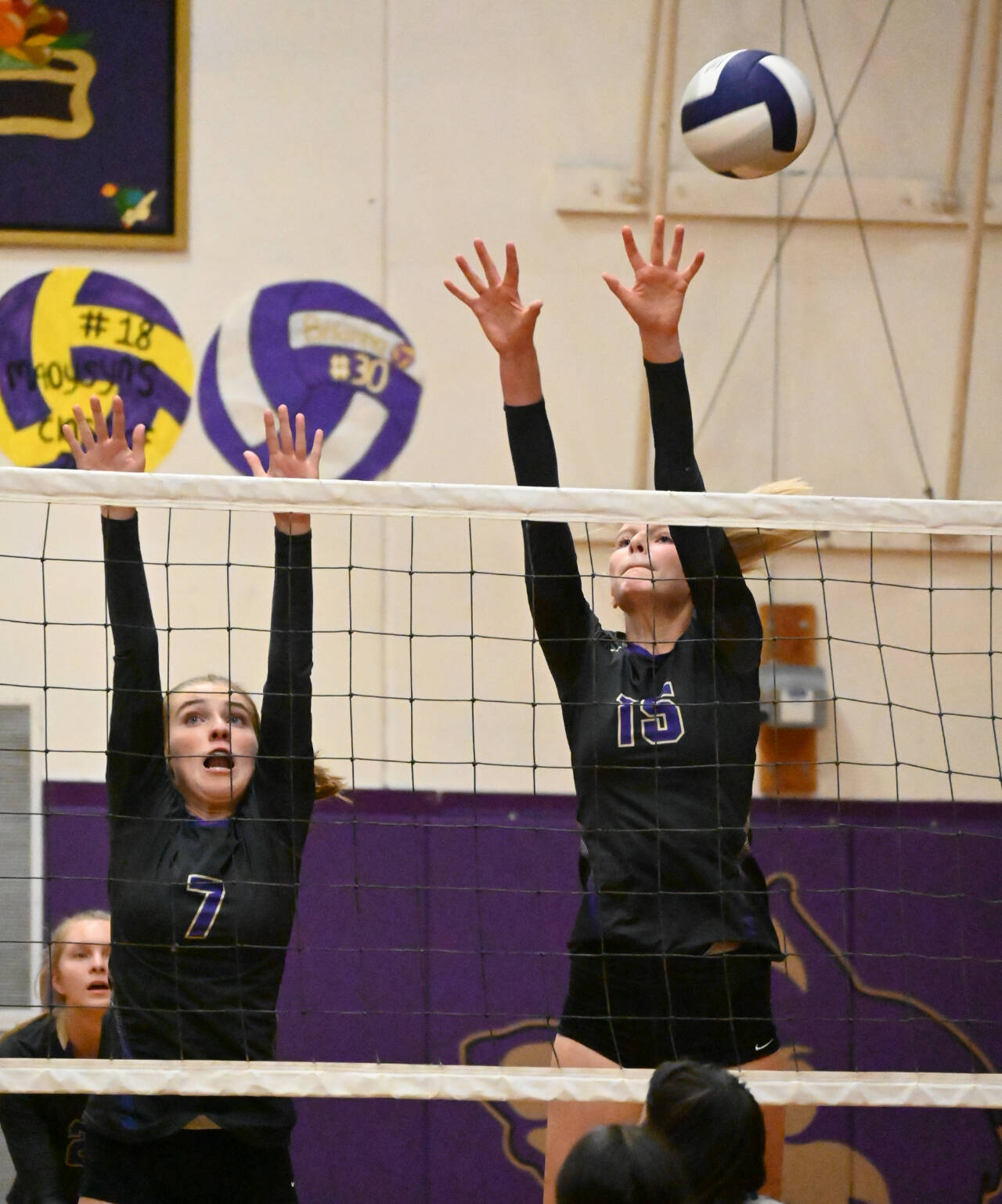 Sequim Gazette photo by Michael Dashiell / Sequim’s Sydney Clark, left, and Kendall Hastings vie for a block in the Wolves’ league match-up against Olympic on Sept. 20.