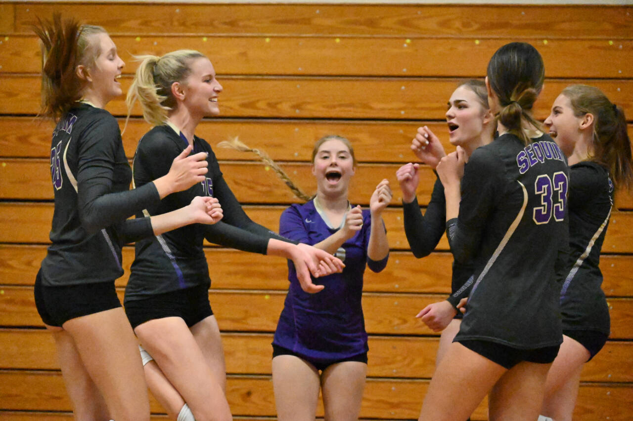 Sequim Gazette photo by Michael Dashiell / Sequim High volleyball teammates celebrate a point in the first game of a Sept. 20 league match-up against Olympic on Sept. 20.