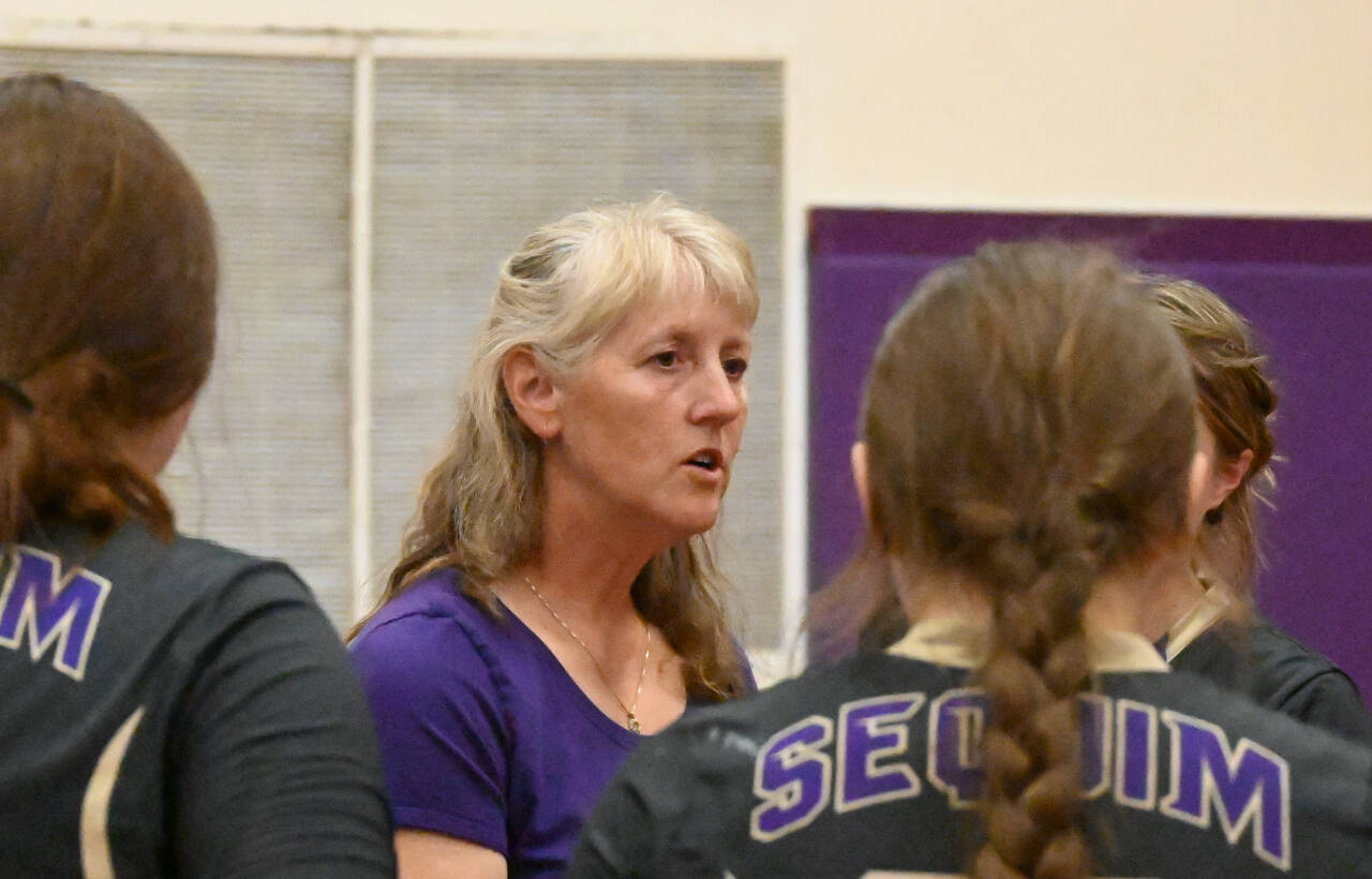 Sequim Gazette photo by Michael Dashiell / Sequim High volleyball coach Jennie Webber Heilman talks with her team in a home league match-up against Olympic on Sept. 20.