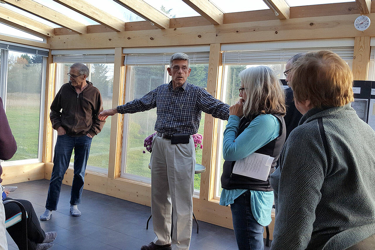 Submitted photo
David Large leads a small tour in Nov. 2021 of his home that produces more energy than it uses. He hosts an open house 9 a.m.-5 p.m. Saturday, Oct. 1, at 173 Griffith Farm Road in Sequim.