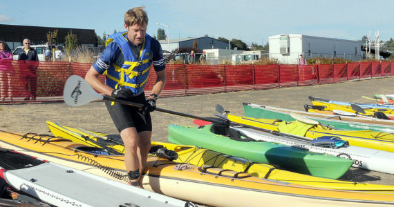 KEITH THORPE/PENINSULA DAILY NEWS
Ian Mackie of Gig Harbor prepares to launch his kayak from Pebble Beach as an iron man competitor during Saturday's Big Hurt in Port Angeles.