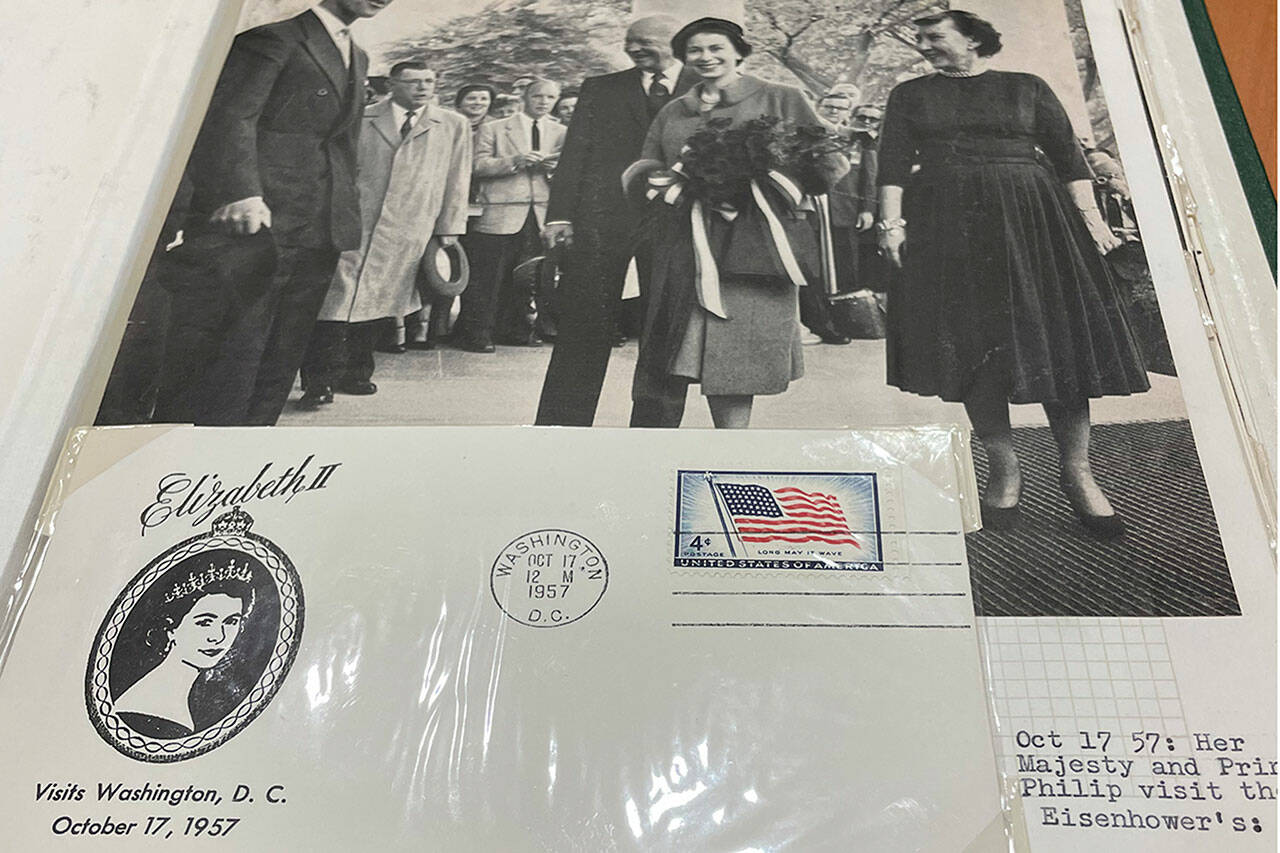 Sequim Gazette photo by Matthew Nash/ In Phil Castell’s stamp collection is a book someone compiled of the British royal family’s life through stamps, postcards, envelopes, clippings and more. Here, it shows Queen Elizabeth II visiting the White House in 1957.