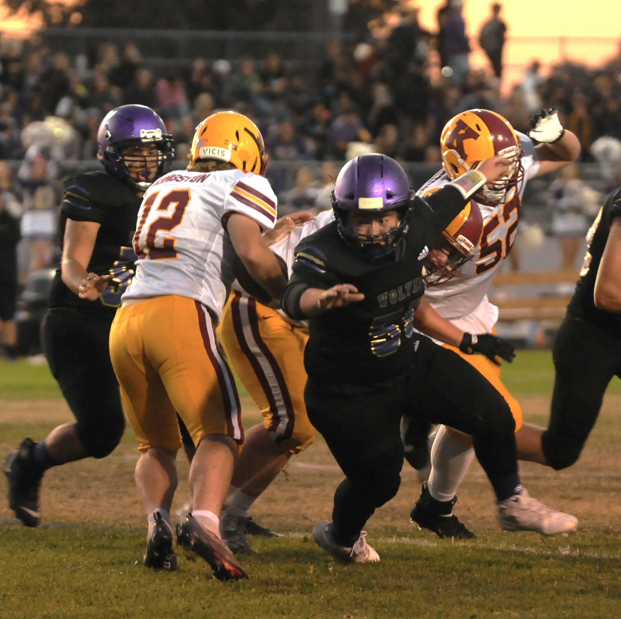Sequim Gazette photo by Michael Dashiell / Sequim’s Ayden Holland tries to wrap up Kingston quarterback Brooks Arnim in a Sept. 30 Olympic League match-up. Holland’s Wolves won, 27-13.