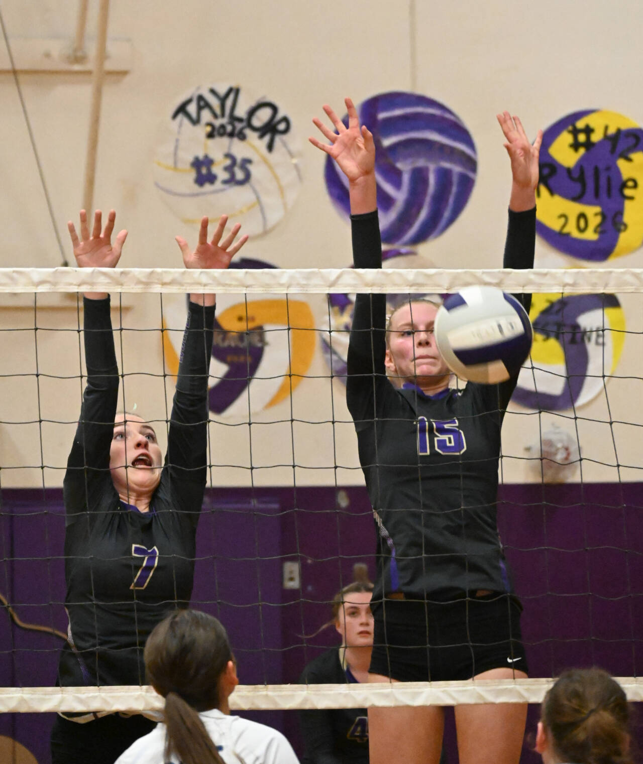 Sequim Gazette photo by Michael Dashiell 
Sequim’s Sydney Clark, left, and Kendall Hastings looks to block a hit in the Wolves’ four-set home win over North Mason’s Bulldogs on Sept. 6.