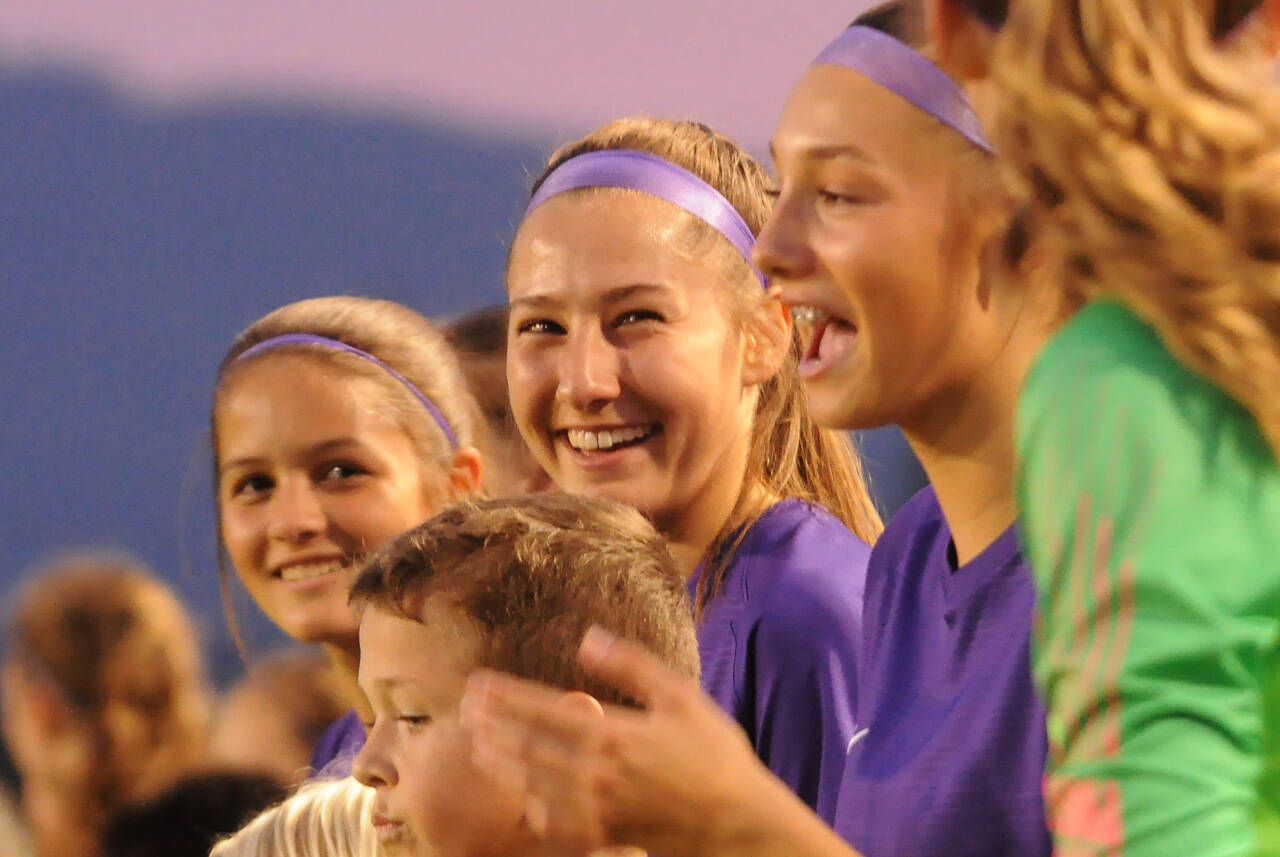 Sequim Gazette photos by Michael Dashiell
Taryn Johnson, center, and teammates — joined by Sequim Junior Soccer players — are introduced before their Olympic League match-up with North Mason on Oct. 6. Johnson set the SHS girls soccer program’s record for career goals.