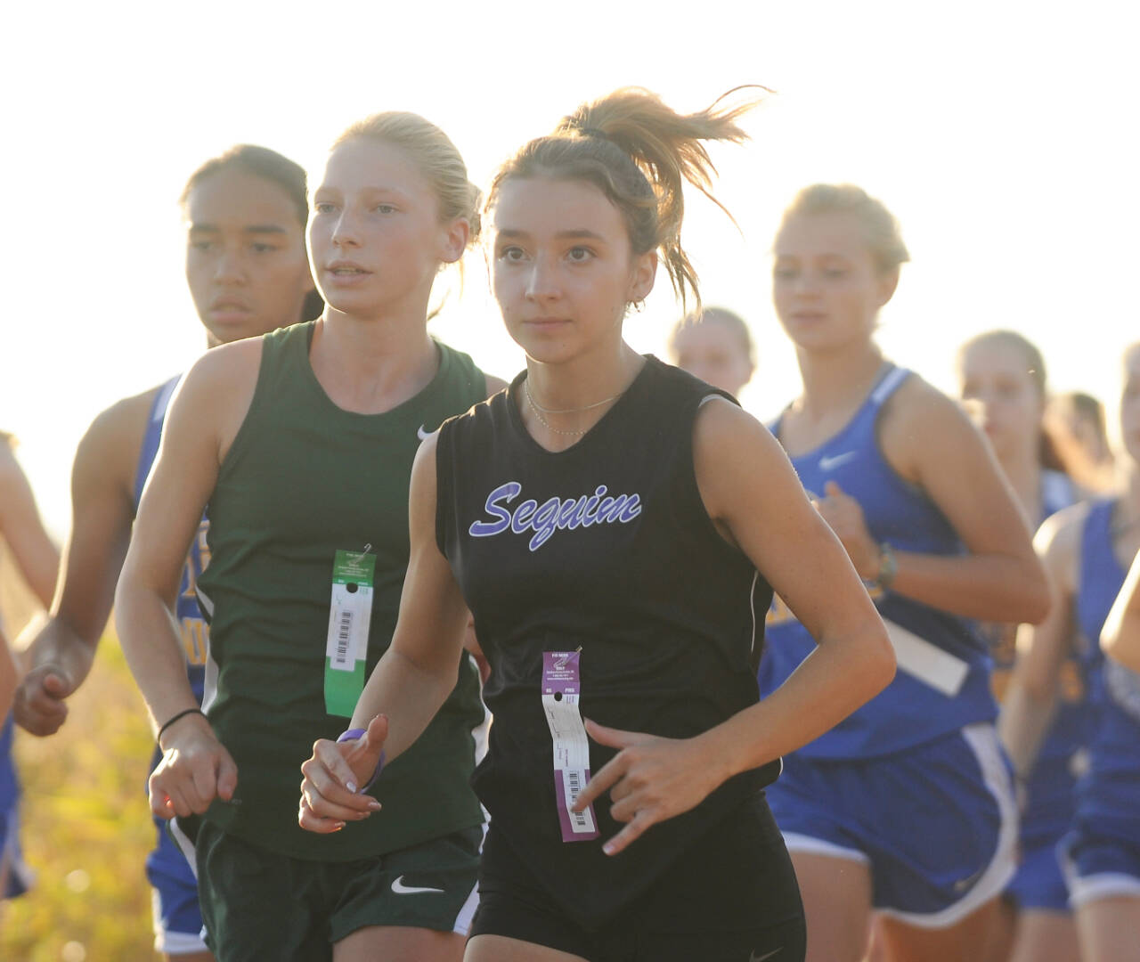Sequim Gazette photo by Michael Dashiell / Sequim’s Kaitlin Bloomenrader races at an Olympic League meet on Oct. 12 at Voice of America Park in Sequim. Bloomenrader was fourth in the meet (21:04). Port Angeles freshman Leia Larson, left, was 10th.