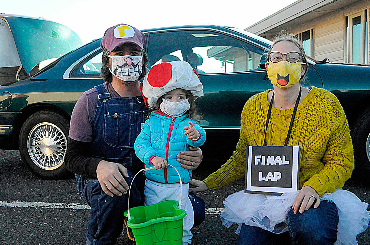 Sequim Gazette file photo by Matthew Nash/ The “Mario Kart” family of Adele as Toad, Tom as Waluigi and Liz Duval as a Koopa Troopa race car attendant race through Faith Lutheran’s trunk-or-treat in 2021. The parents said they played a lot of the video game during the pandemic. The church’s event returns on Halloween from 5-6:30 p.m. Oct. 31.