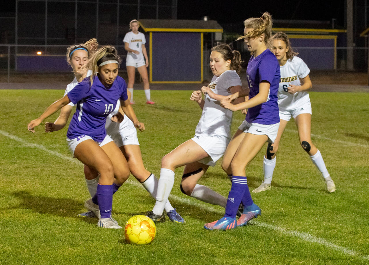 Sequim Gazette photo by Emily Matthiessen / Sequim’s Jennyfer Gomez (10) and Kiley Winter (8) vie for possession in the Wolves’ 5-3 loss to visiting Bainbridge on Oct. 20.