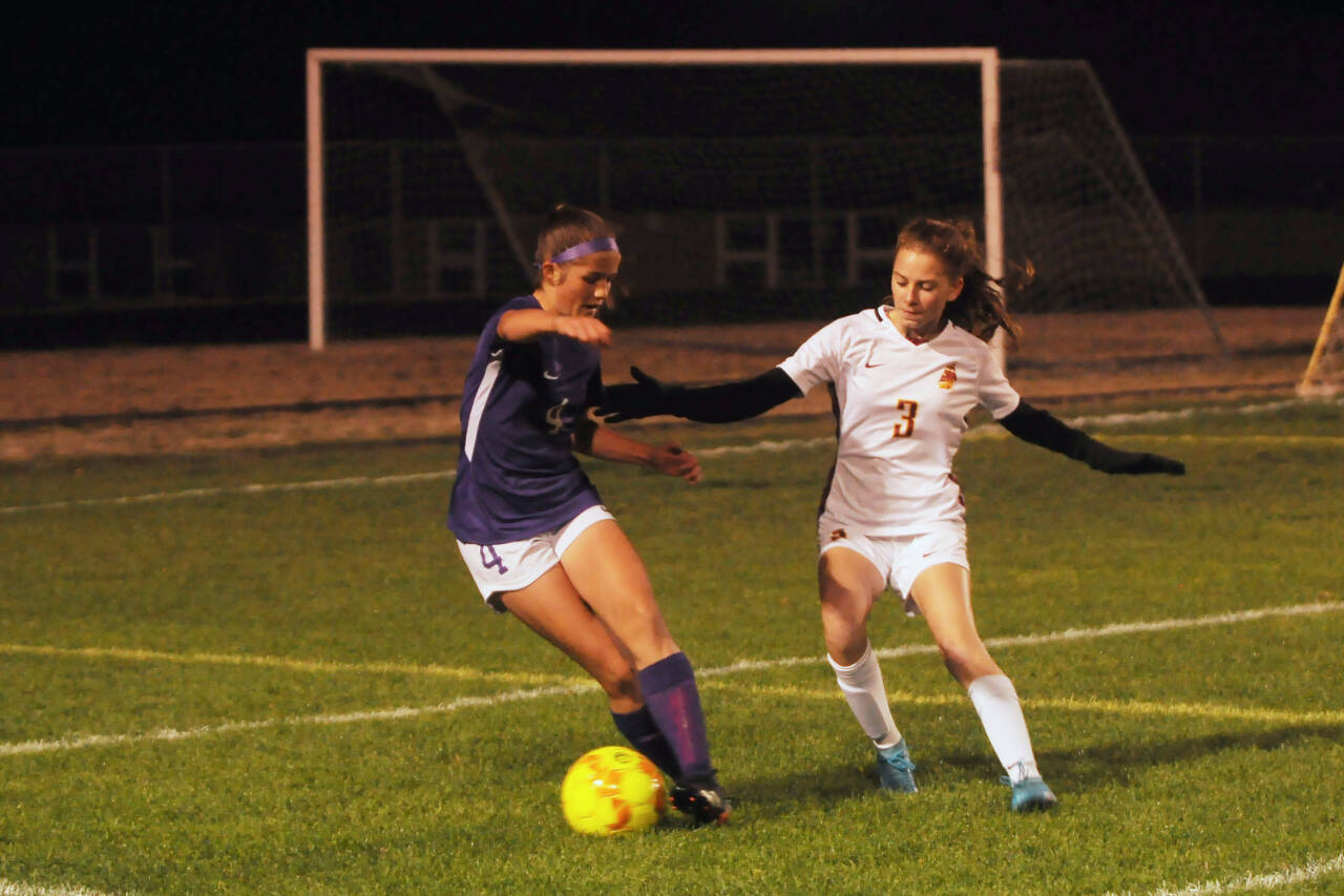Sequim Gazette photo by Michael Dashiell / Sequim’s Raimey Brewer, left, looks to get past Kingston defender Faith Collins in SHS’s 4-0 win over the visiting Buccaneers on Oct. 27.
