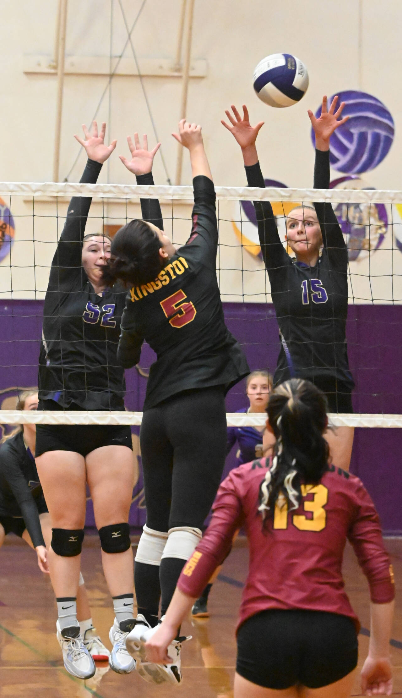 Sequim Gazette photo by Michael Dashiell / Sequim’s Sammie Bacon, left, and Kendall Hastings looks to block a hit by Kingston’s Grace Mosco in the Wolves’ three-game sweep of the Buccaneers on Oct. 27.
