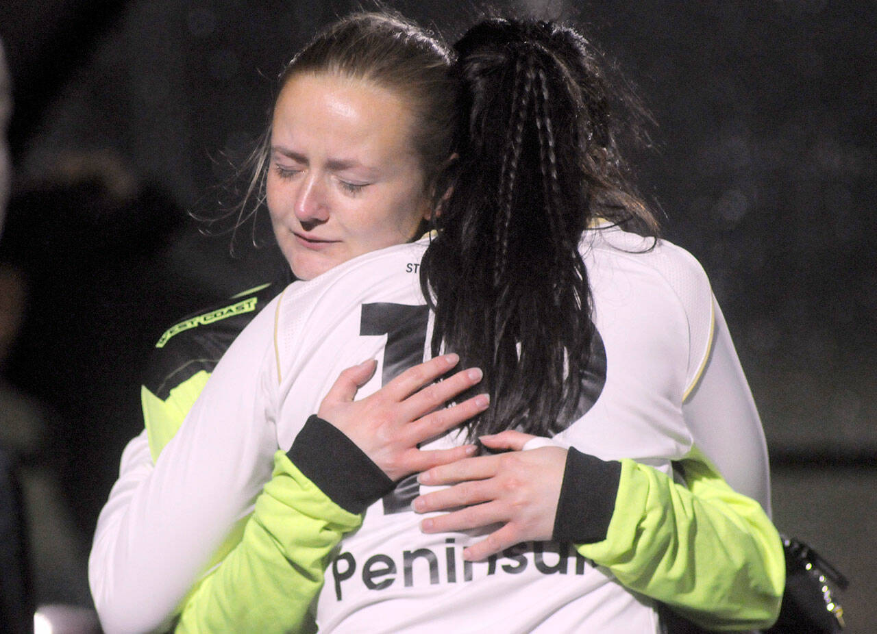 Photo by Keith Thorpe/Olympic Peninsula News Group / Peninsula goalkeeper Frida Markstrom gets a hug from teammate Keilee Silva after falling short during a penalty shootout to determine a winner of the NWAC semifinal match against Spokane on Nov. 5 in Port Angeles.