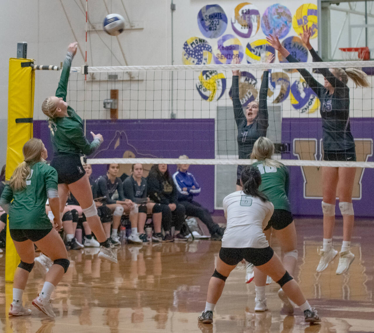 Sequim Gazette photo by Emily Matthiessen / Port Angeles’ Alaina Baublitz, left, looks to hit past the block of Sequim’s Sydney Clark, center, and Kendall Hastings in an Olympic League tournament game on Nov. 3 in Sequim. The host Wolves topped PA’s Roughriders in three games.