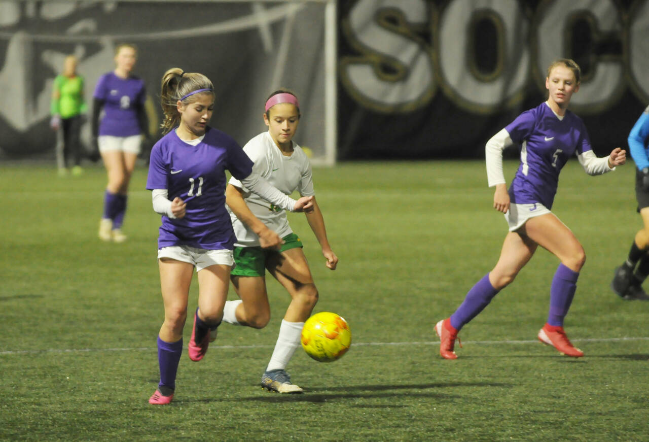 Sequim Gazette photo by Michael Dashiell / As teammate Ivy Barrett, right, looks on, Sequim’s Alliyah Weber advances the ball into Clover Park territory in the Wolves’ 2-0 win on Nov. 1.