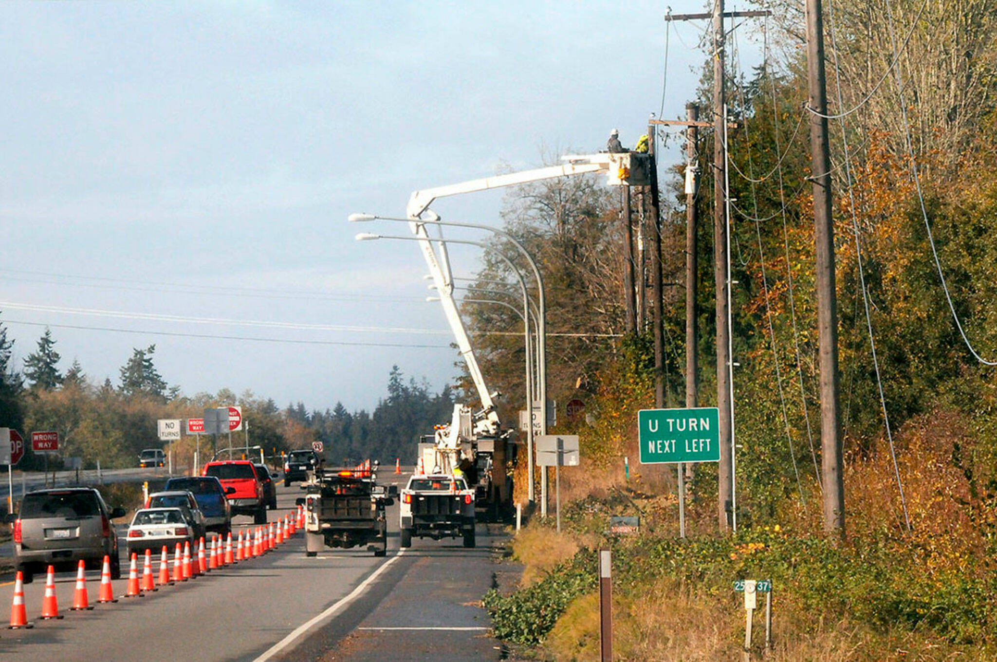 Keith Thorpe/ Olympic Peninsula News Group/ A line crew from Clallam PUD works to repair a powerline along U.S. Highway 101 west of Barr Road on Saturday, Nov. 5.