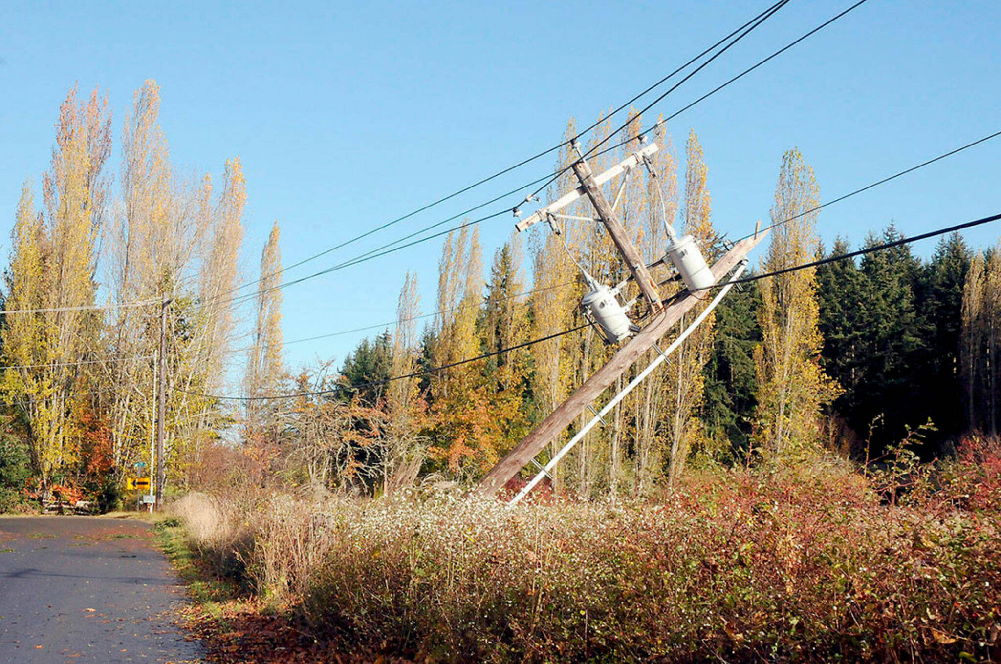 Keith Thorpe/ Olympic Peninsula News Group/ Electrical transformers dangle from powerlines on Saturday, Nov. 5 after a power pole was snapped by a toppled tree along Gilbert Road near Carlsborg.