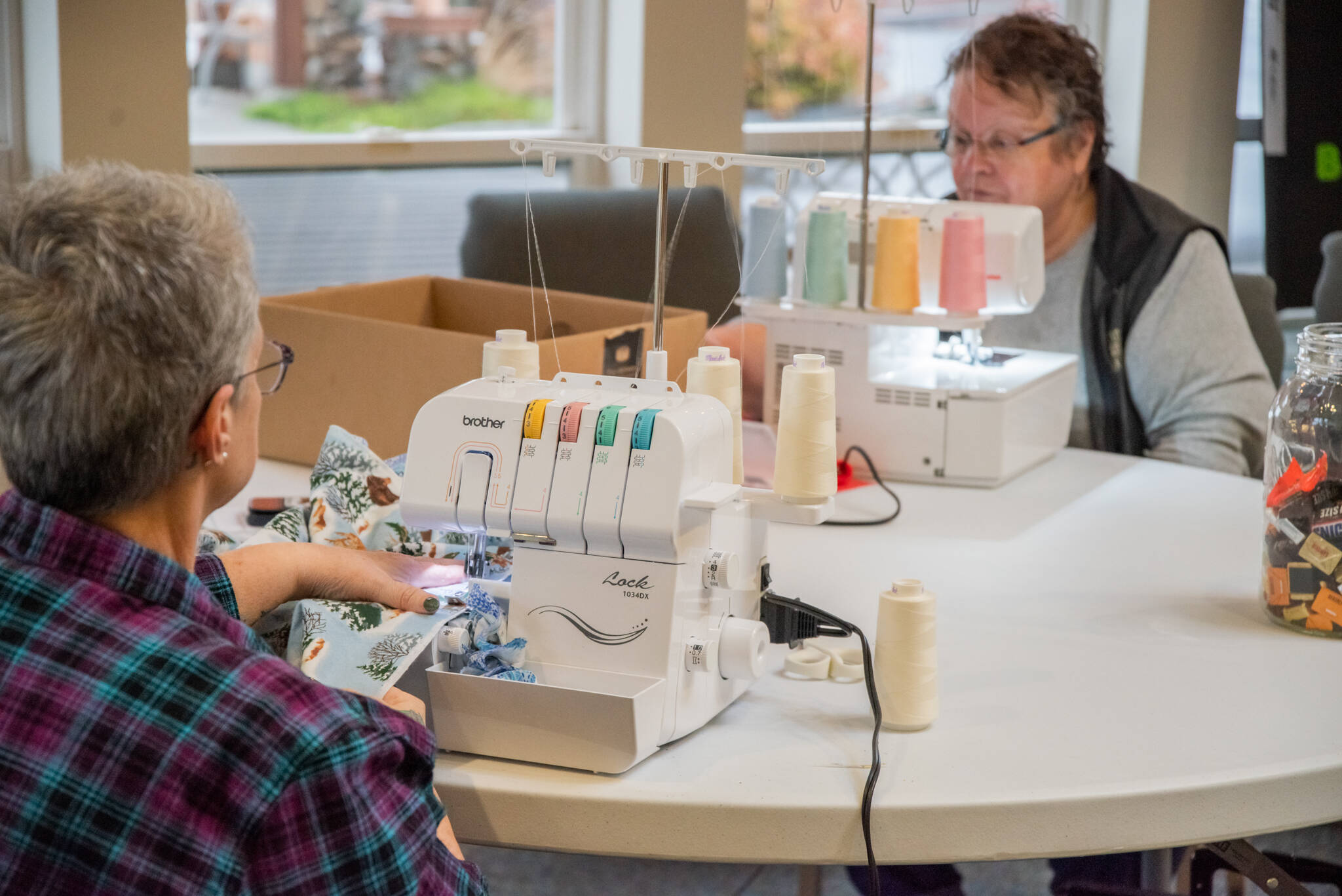 Emily Matthiessen/Sequim Gazette photos
Members of the Sequim Serger Squad, Gail Schwab (left) and Gerri Frick, finish blankets for children in need on their serger machines. “I don’t always get a chance to use a hobby in a way to help the community,” Frick said. “It feels good to do that.”