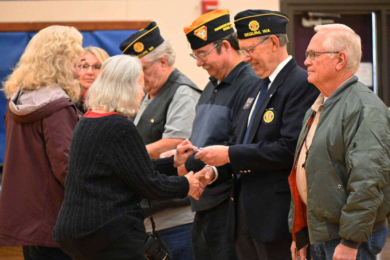 Sequim Gazette photo by Michael Dashiell / Members of the Michael Trebert Chapter of the Daughters of the American Revolution honor veterans with pins at a Veterans Day ceremony at Olympic Peninsula Academy and Dungeness Virtual School on Nov. 9.