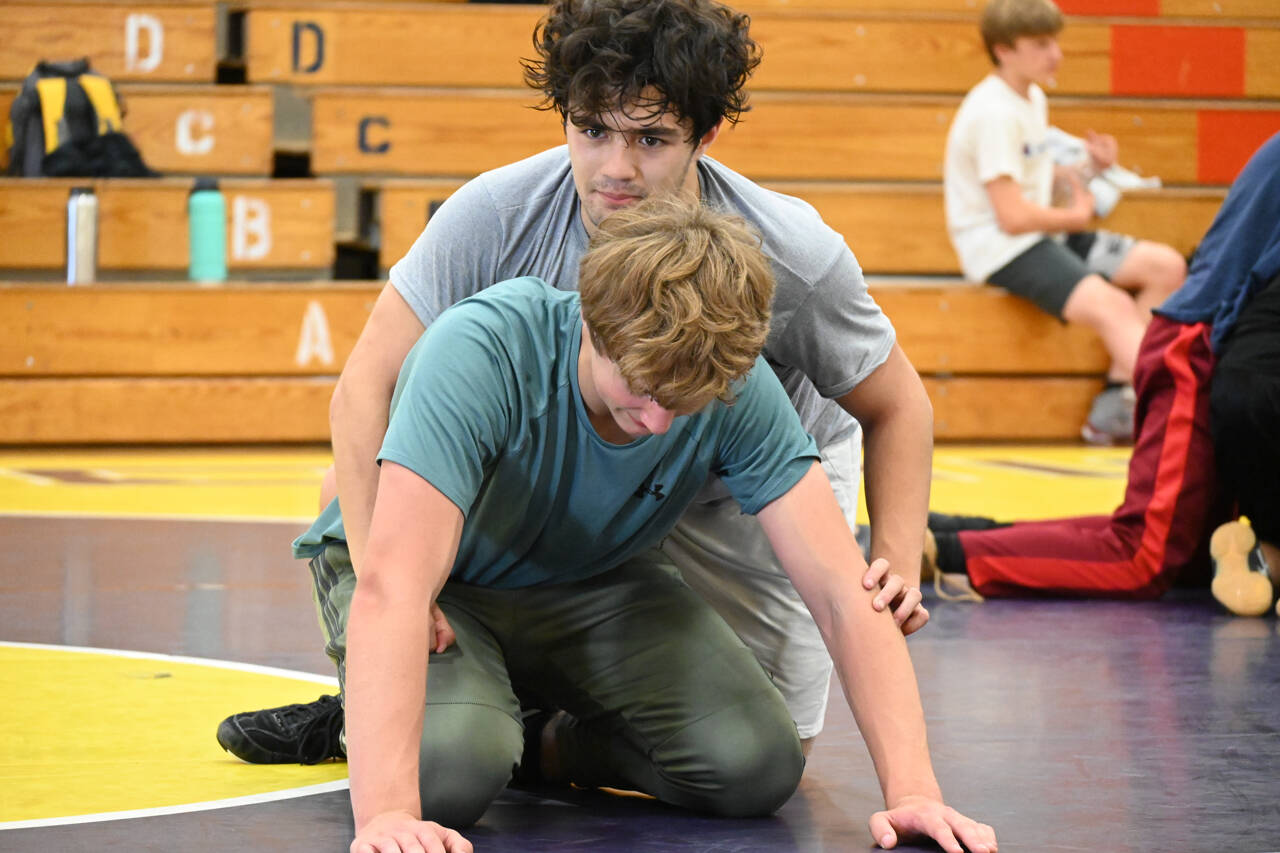 Sequim Gazette PHOTO BY Michael Dashiell
Aaron Tolberd, top, and Ari Skov work on a move at a wrestling camp in Sequim in July.