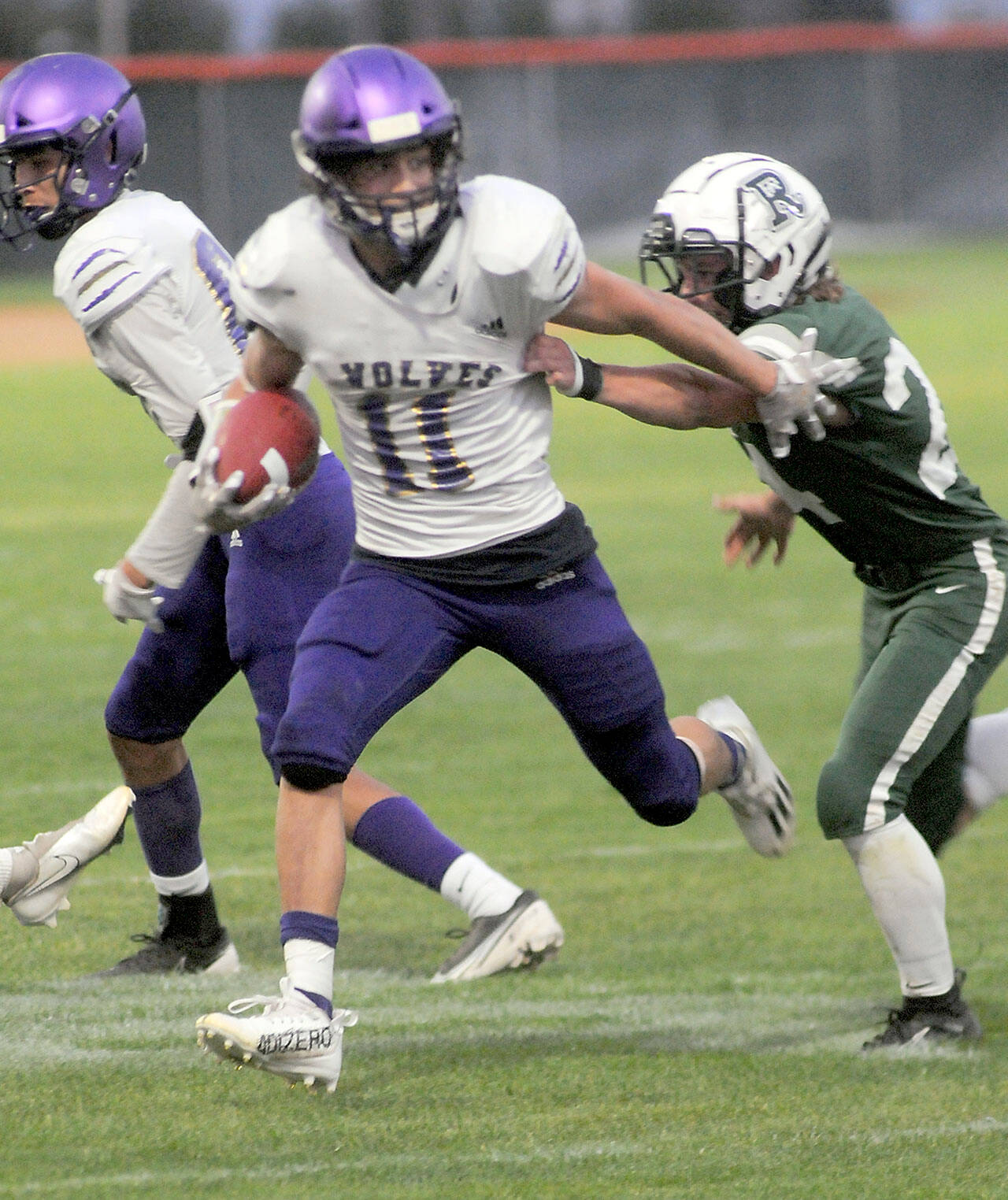File photo byKeith Thorpe/Olympic Peninsula News group / Sequim’s Aiden Gockerell, pictured here fending off a would-be tackle by Port Angeles’ James Browning in September, was named an all-Olympic League first teamer on offense and defense.