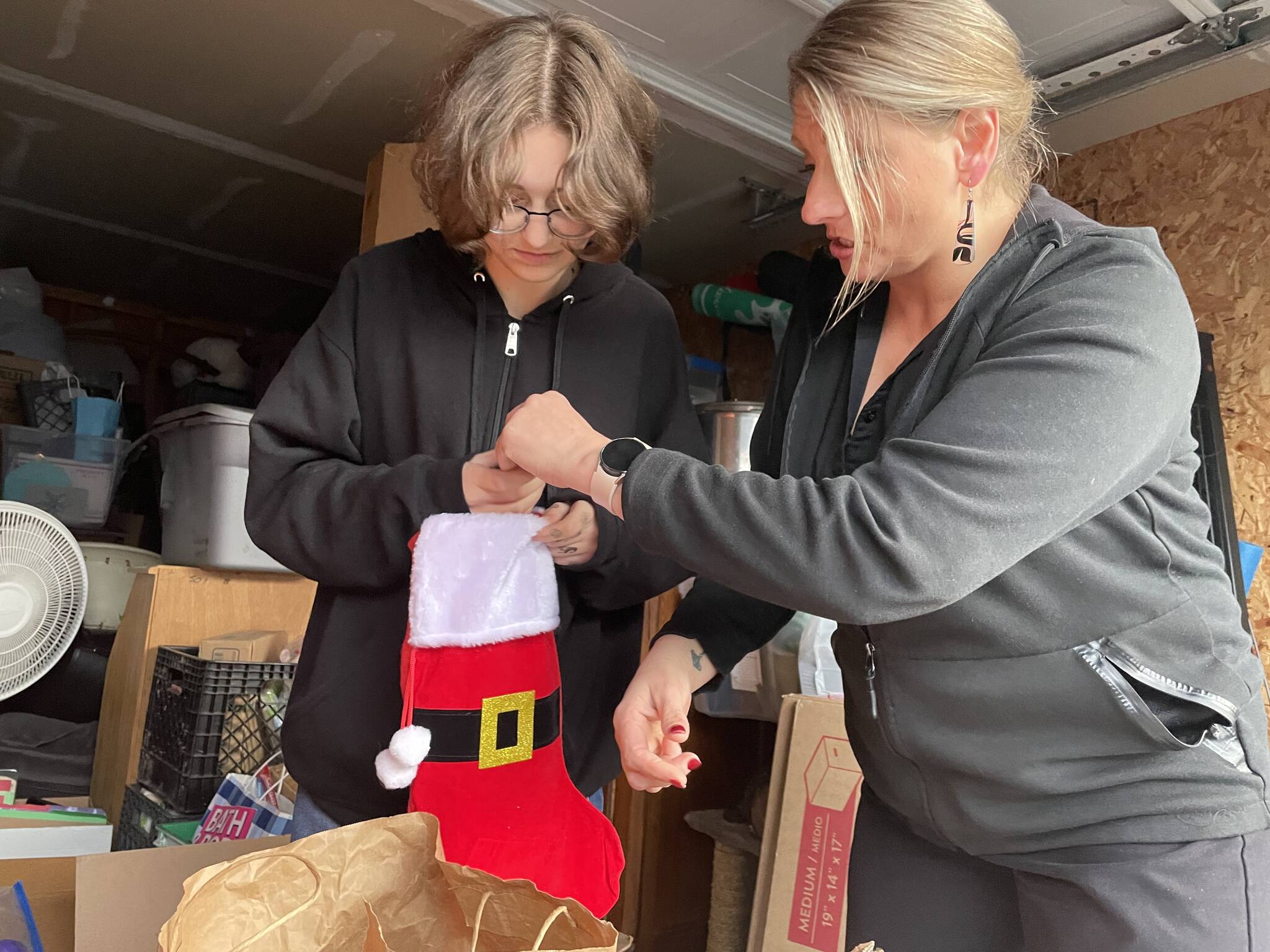 Sequim Gazette photo by Matthew Nash/ River Jensen, left, and her mom Anna Larsen say donations of toiletries are down this year for River’s Christmas Project to supply stockings with toiletries, gloves, winter hats and more. They plan to supply the stockings to local agencies prior to Christmas.