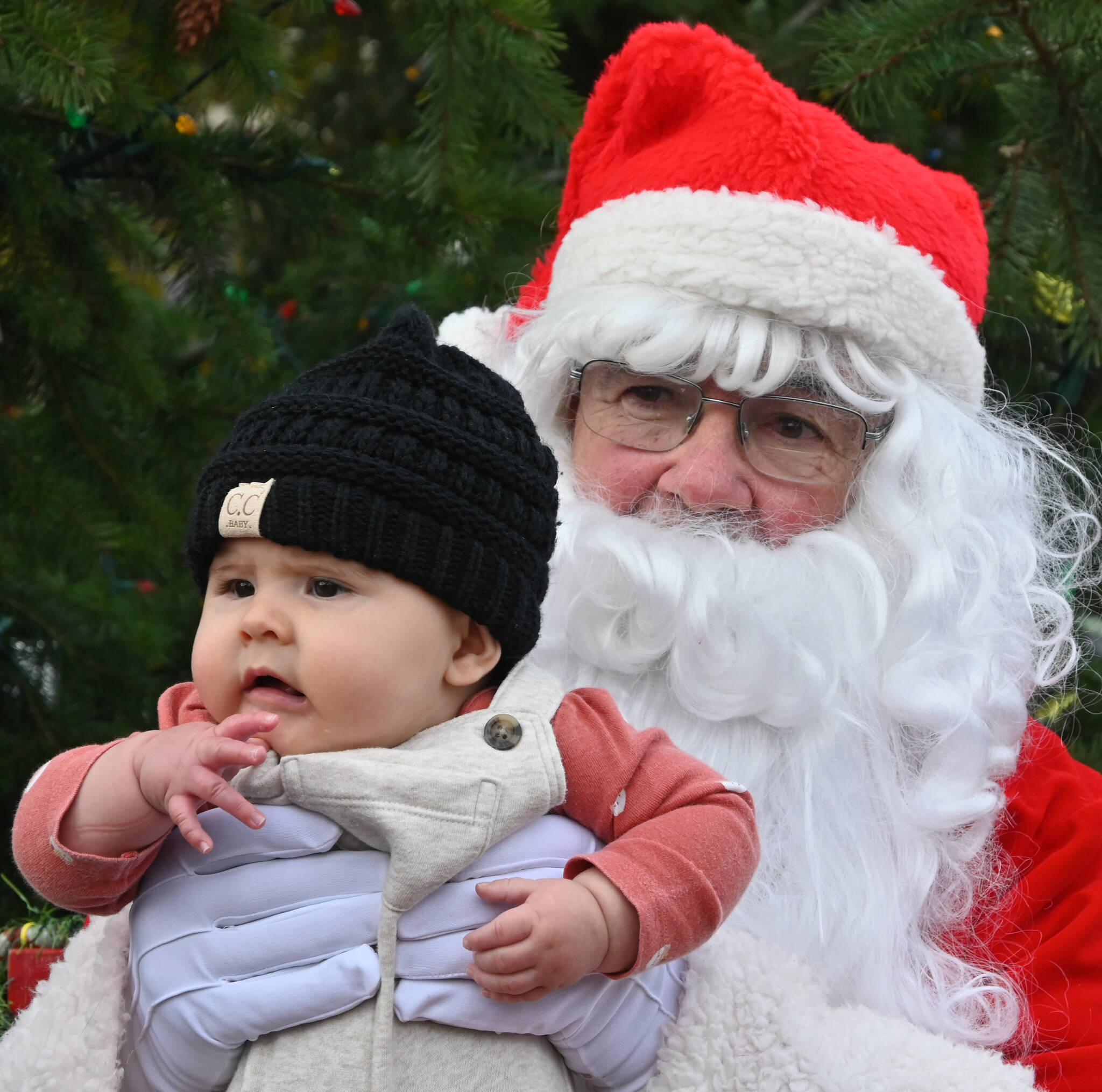 Sequim Gazette photo by Michael Dashiell / Five-month-old Maisy Gonzalez spends some quality time with Santa Claus (Stephen Rosales) at the Hometown Holidays event Saturday afternoon in downtown Sequim.