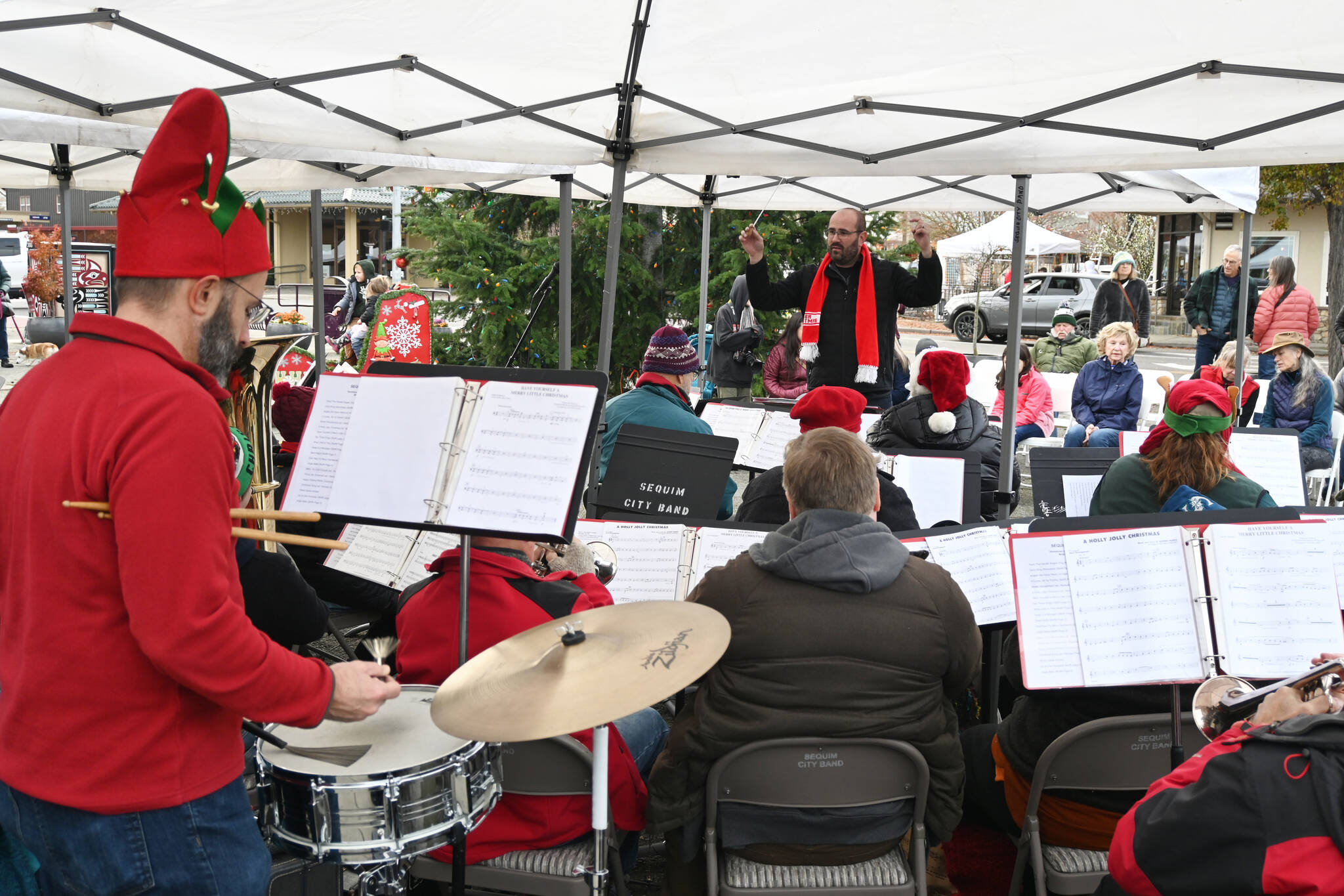 The Sequim City Band plays holiday-themed songs at Centennial Place on Saturday, as part of the live music at the Hometown Holidays event in downtown Sequim.