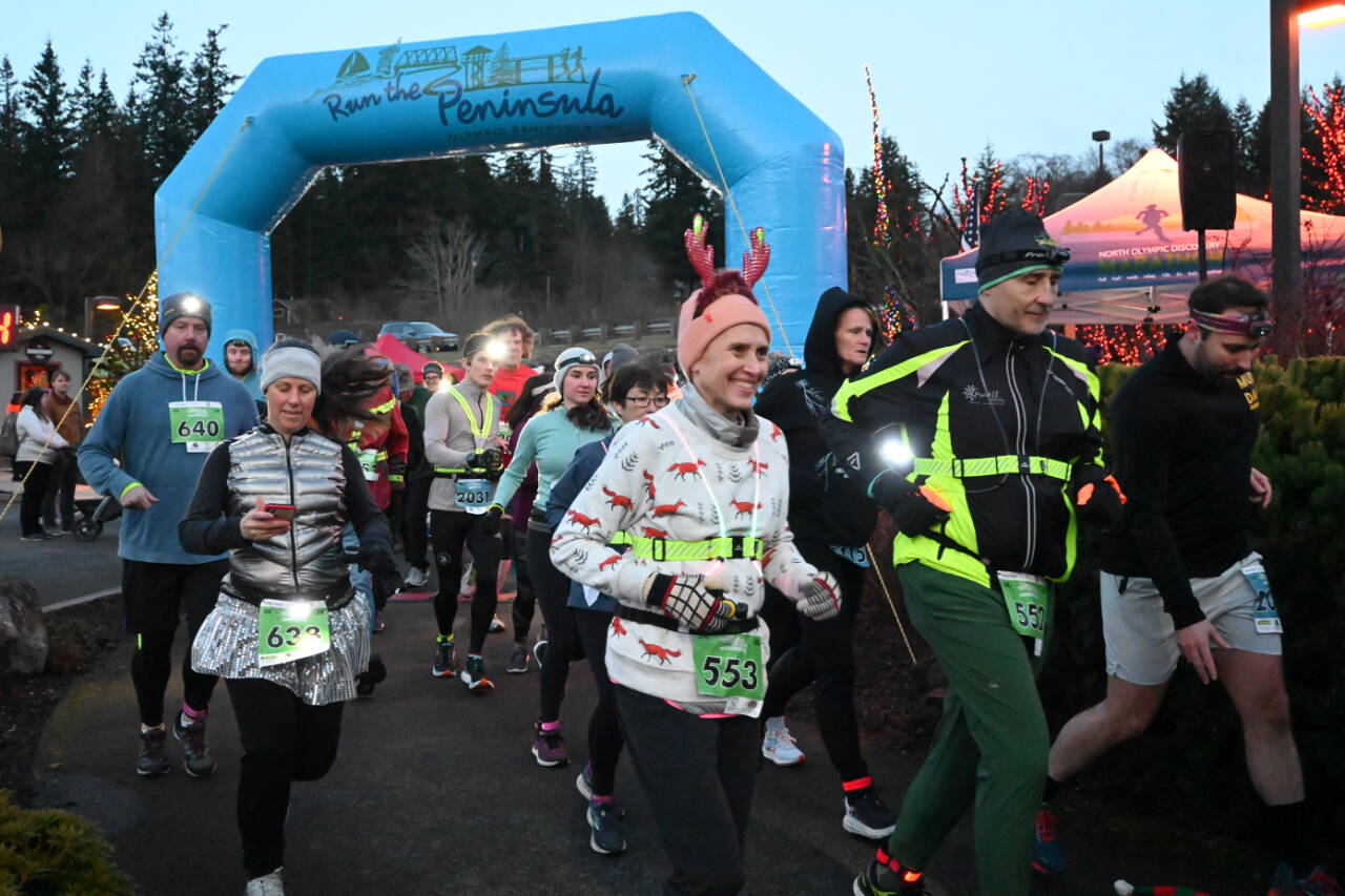 Sequim Gazette photo by Michael Dashiell / Runners and walkers cross the starting line at the 2022 Jamestown S’Klallam Tribe 5k/10k race on Dec. 3. Many participants, including Timea Tihanyi of Seattle (553), wore holiday-themed costumes and flair.