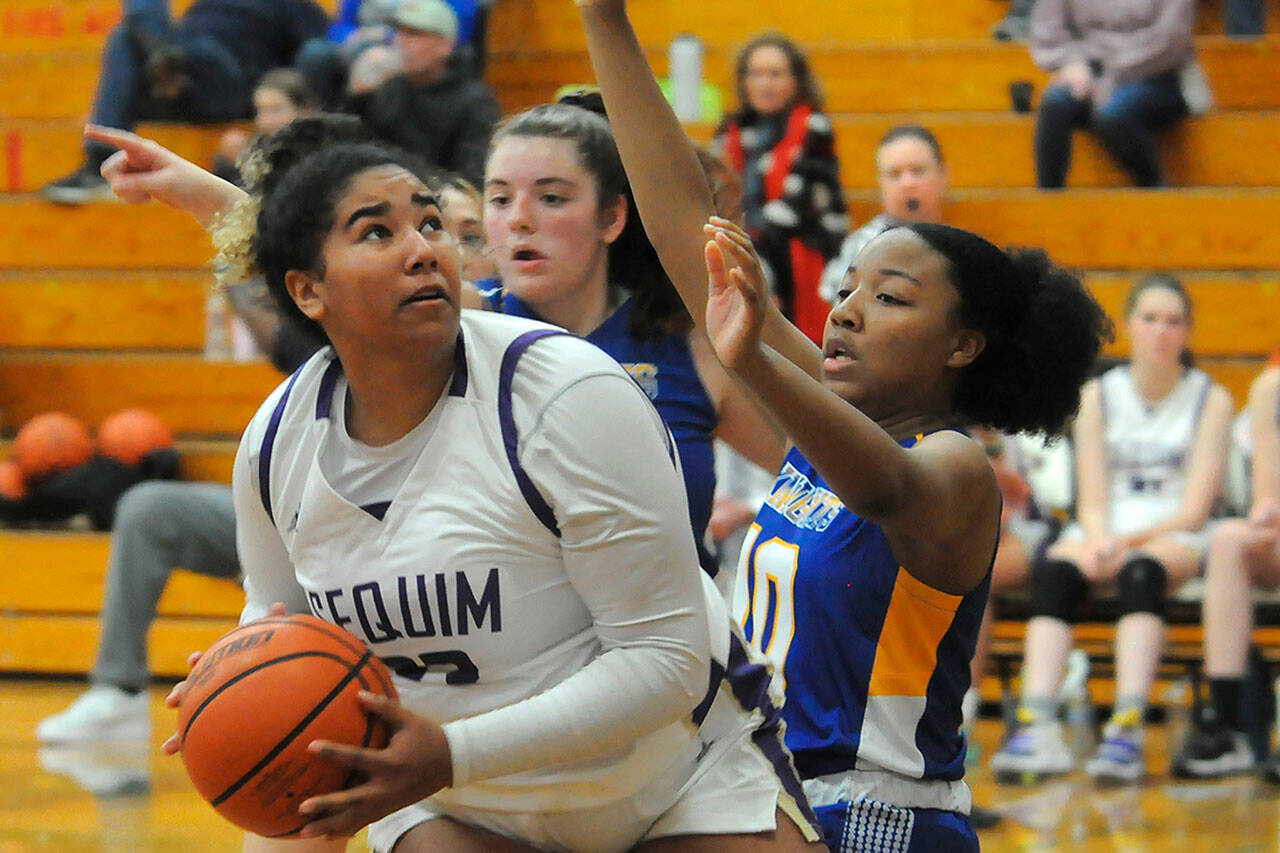 Sequim’s Jelissa Julmist looks to take a shot on Dec. 8 over Bremerton’s Promise Bell. Julmist recorded a double-double in the win with 18 points and 10 rebounds along with three blocks.