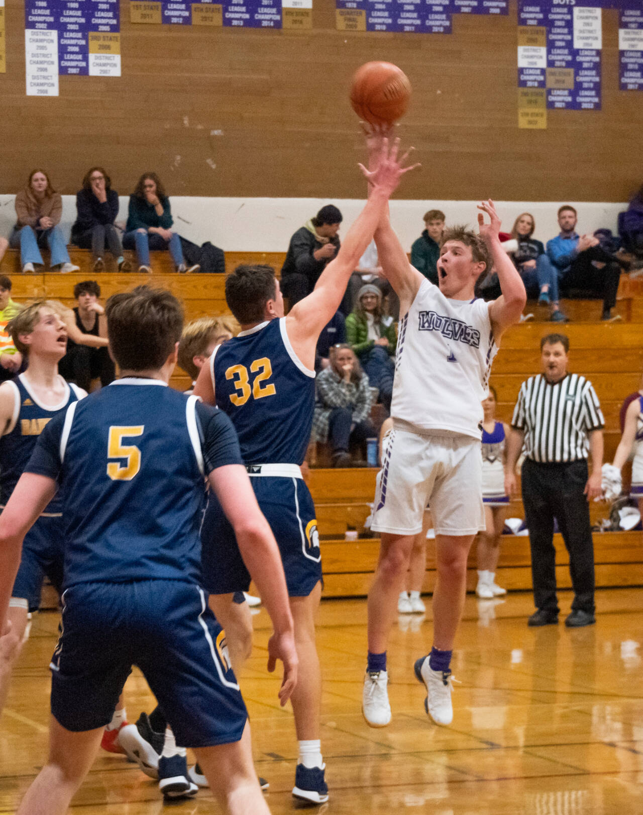 Sequim Gazette photo by Emily Matthiessen Sequims Zackary Thompson, right, takes a jumpshot over Bainbridges Luca Sheltens in Sequims Olympic League match-up with the 3A Spartans on Dec. 6.