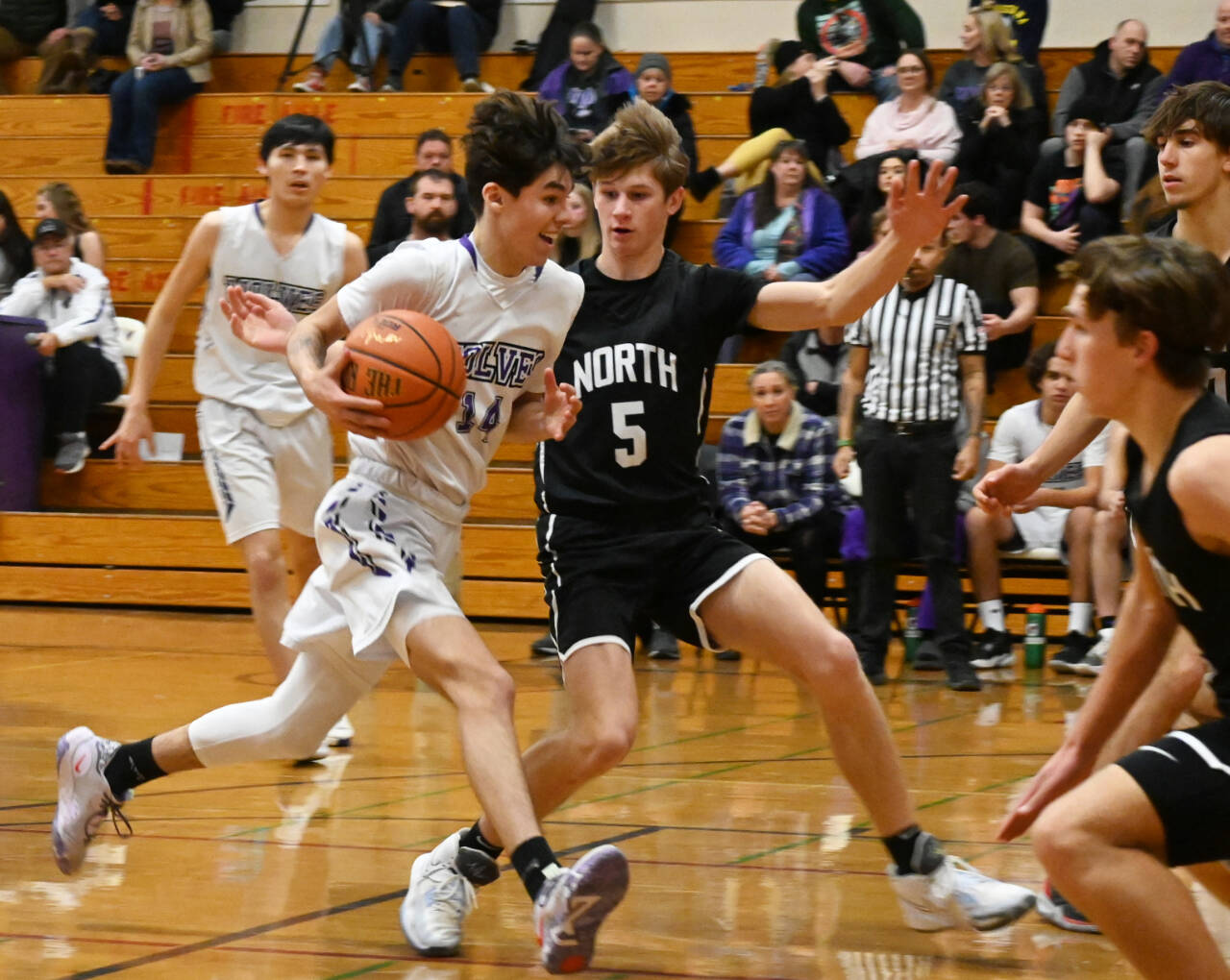 Sequim Gazette photos by Michael Dashiell 
Sequim’s Vincent Carrizosa, left, tries to get past North Kitsap guard Ethan Gillespie in a Dec. 19 Olympic League match-up.
