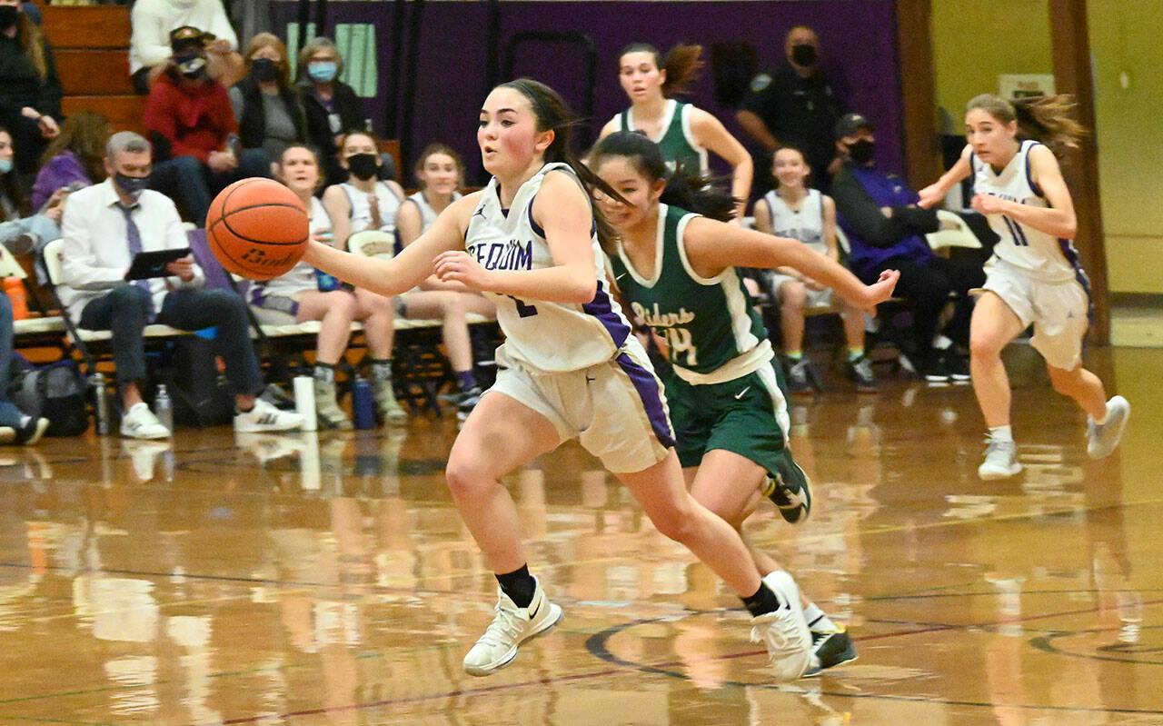 Sequim Gazette file photo by Michael Dashiell / Sequim guard Hannah Bates, left, takes a steal and looks for a basket as Port Angeles’ Jenna McGoff gives chase in the Wolves’ 60-55 win over Port Angeles in January.