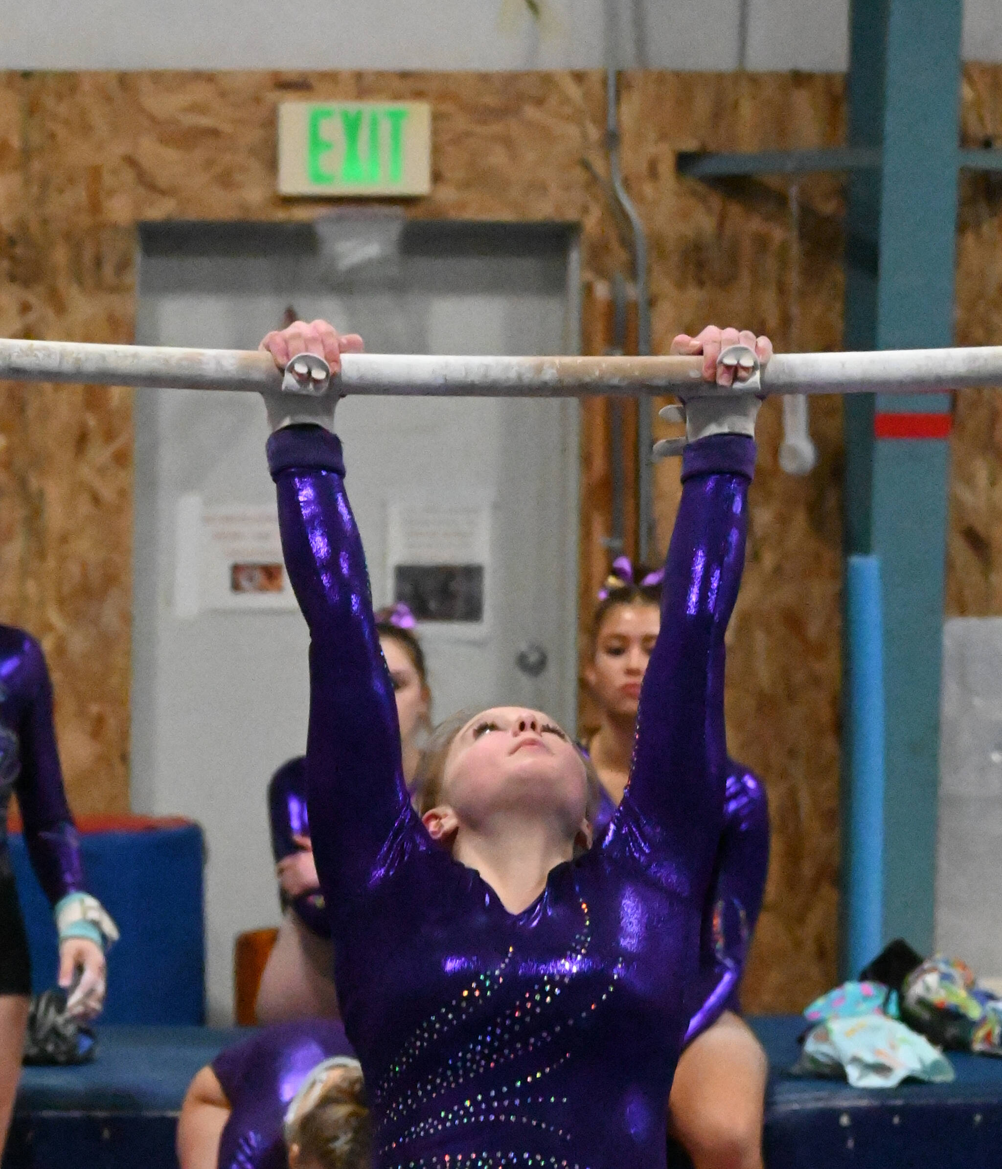 Sequim Gazette photo by Michael Dashiell / Sequim’s Lucy Spelker competes in the bars portion of a league meet against Bainbridge on Jan. 11 in Port Angeles. She placed sixth with 5.9 points.