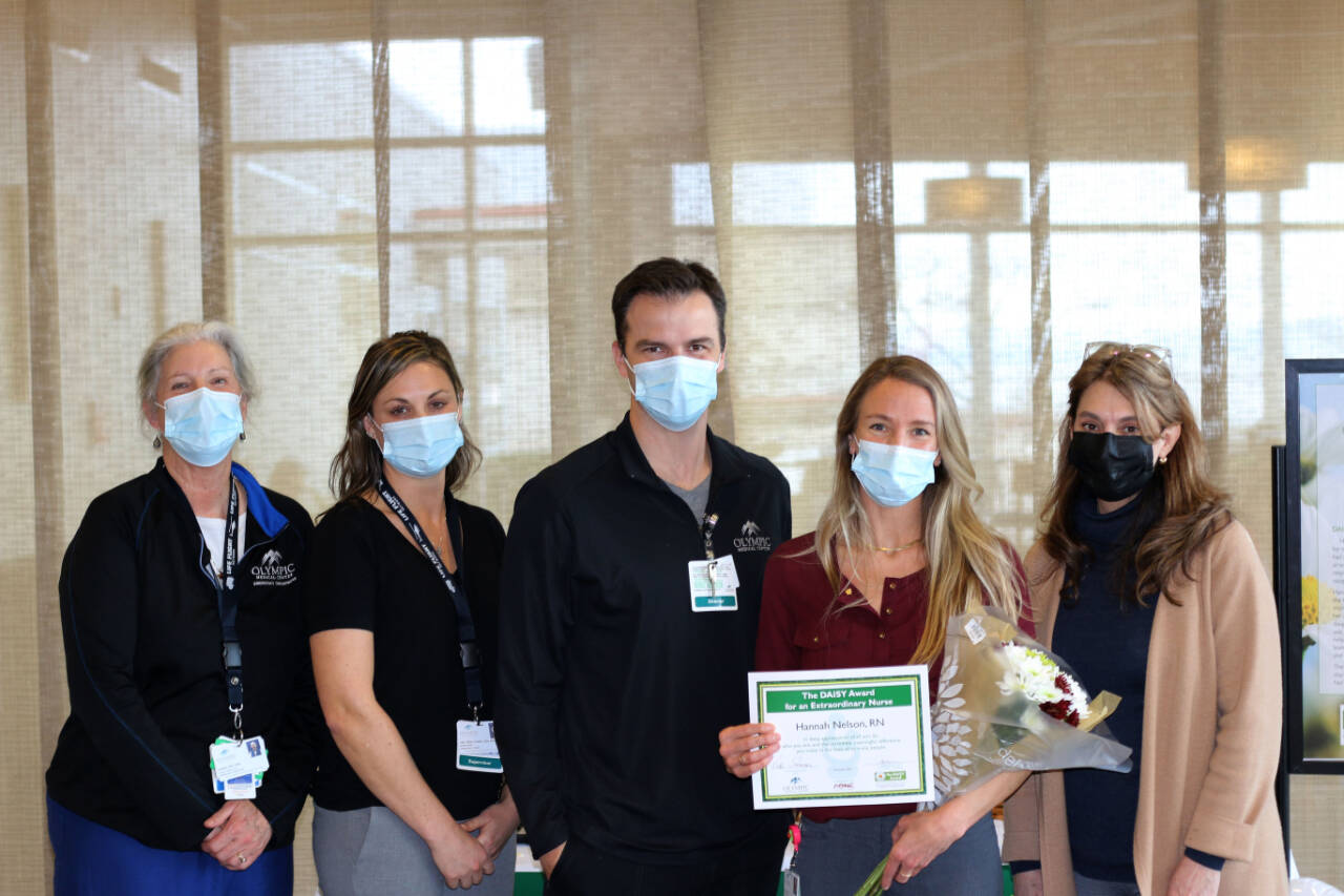 Photo courtesy of Olympic Medical Center / Hannah Nelson, an Olympic Medical Center registered nurse (second from right), receives a DAISY Award for Extraordinary Nurses. Pictured, from left, are Cheri Levy, Jae McGinley, Aaron Possin, Nelson and Vickie Swanson.