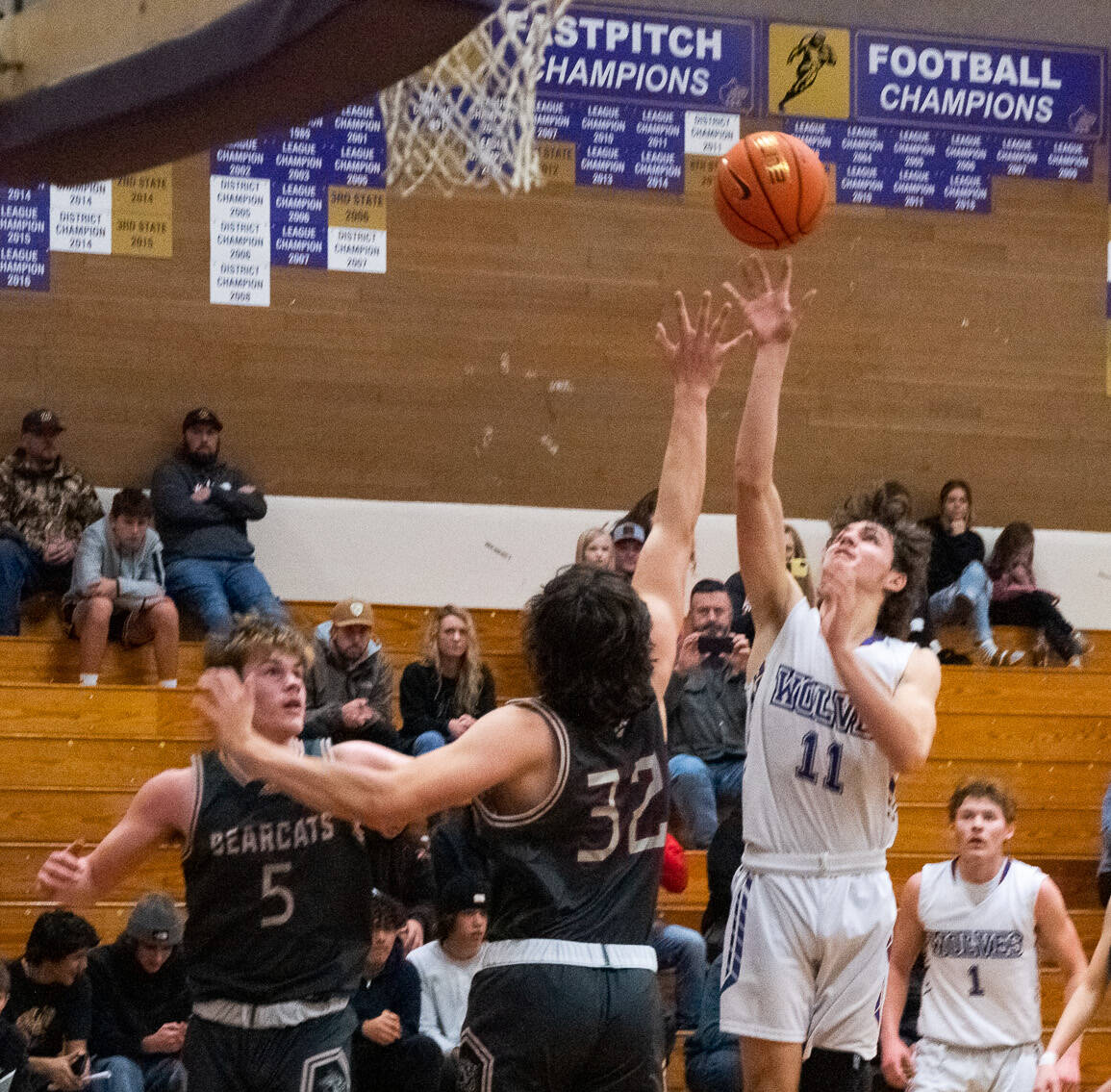 Sequim Gazette photoS by Emily Matthiessen
Sequim’s Charlie Grider puts up a shot over WF West’s Hunter Lutman (32) and Parker Eiswald (5) in the Wolves’ 60-44 loss to the visiting Bearcats on Dec. 27.